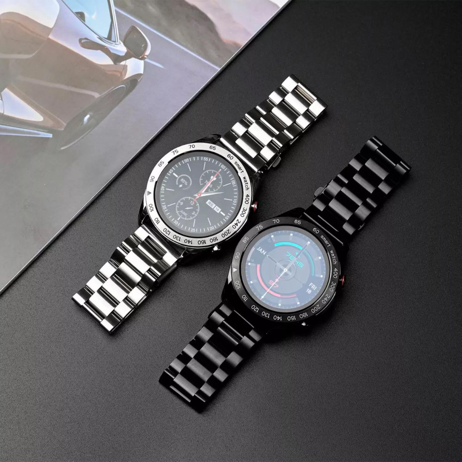 Two smartwatches with metal bands rest on a dark surface next to a car photo.