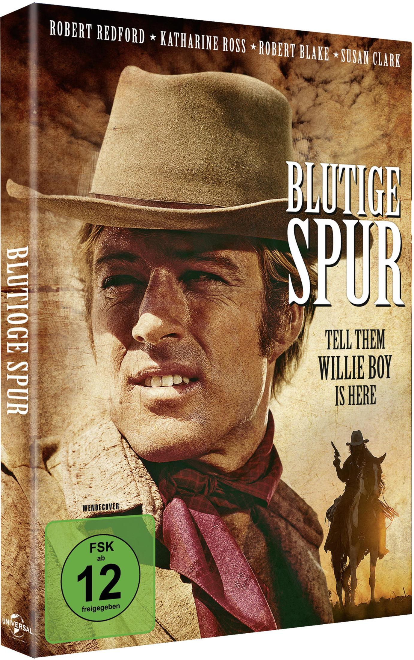 DVD-Cover des Films Blutige Spur mit Robert Redford in einem Hut und Halstuch vor einem Hintergrund mit Text.