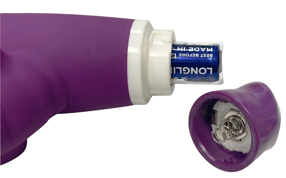 Violettes Gerät mit geöffnetem Batteriefach, blaue Batterie sichtbar und Kappe daneben.