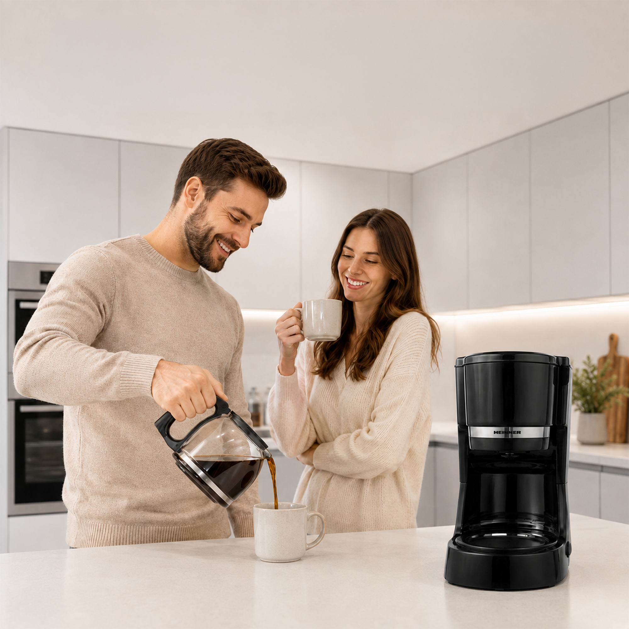 A smiling couple in a modern kitchen as a man pours coffee from a pot into a mug.