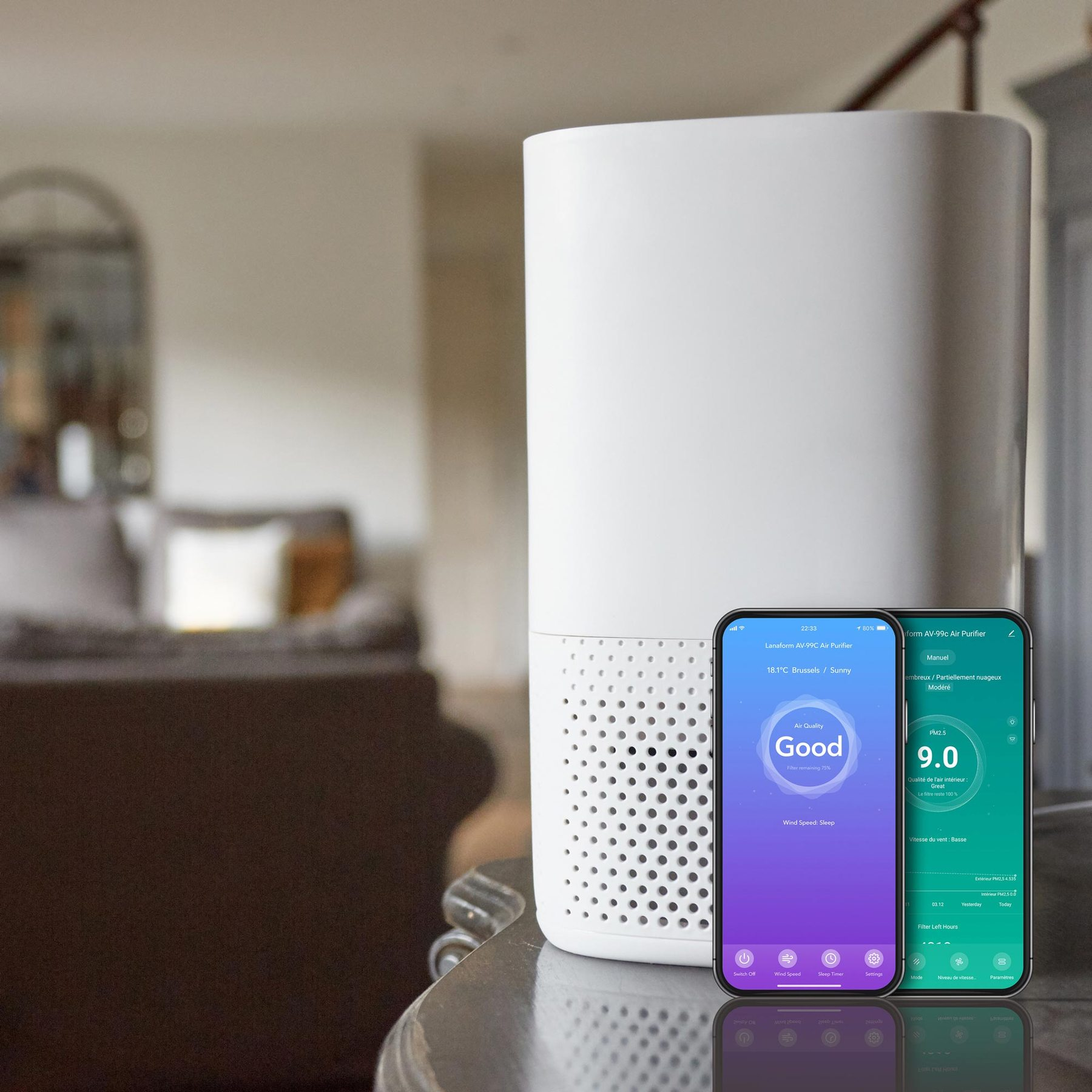 A white air purifier stands on a table, with two smartphones in the foreground showing control apps.