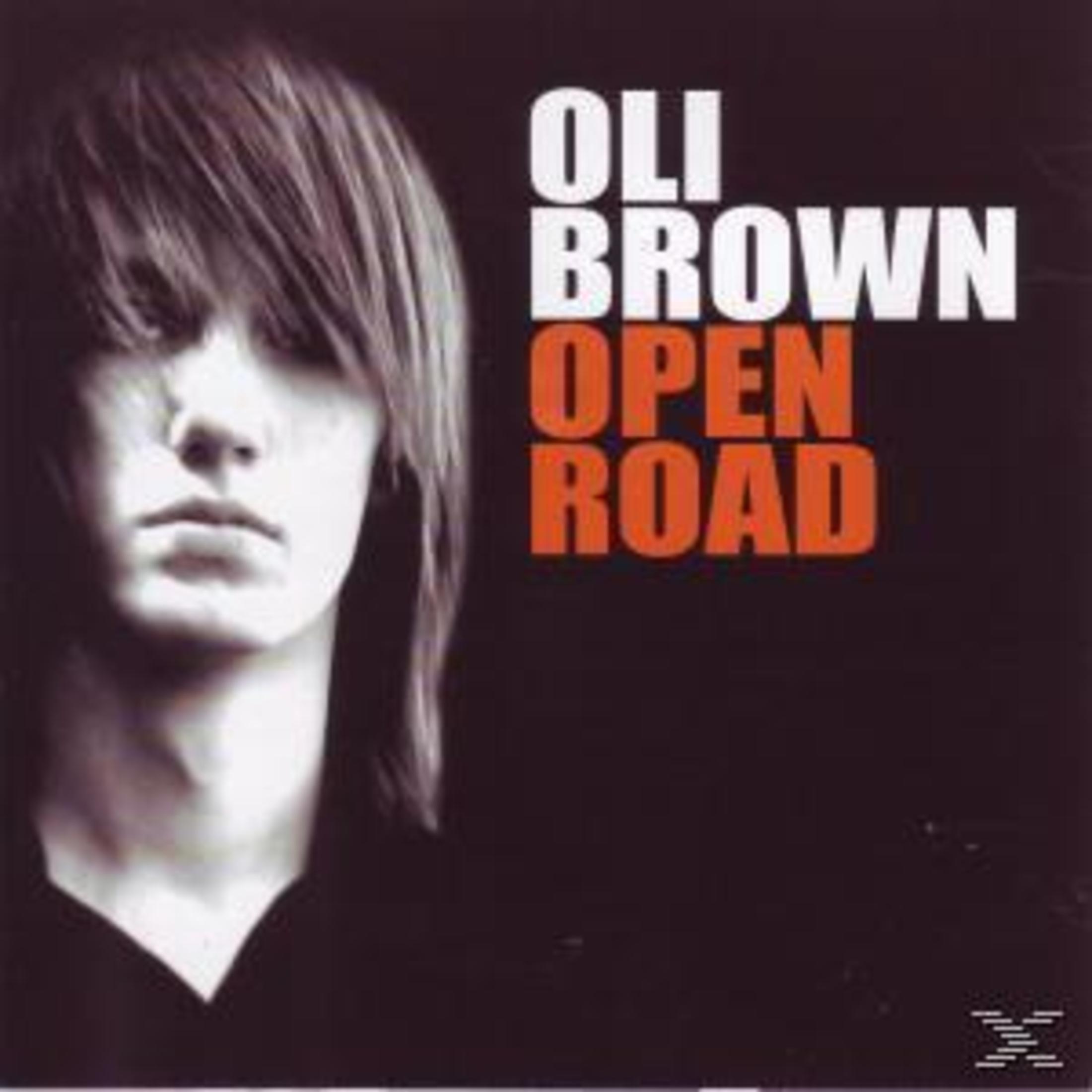Albumcover für Oli Brown Open Road mit einem dunklen Porträt eines jungen Mannes mit langen Haaren.