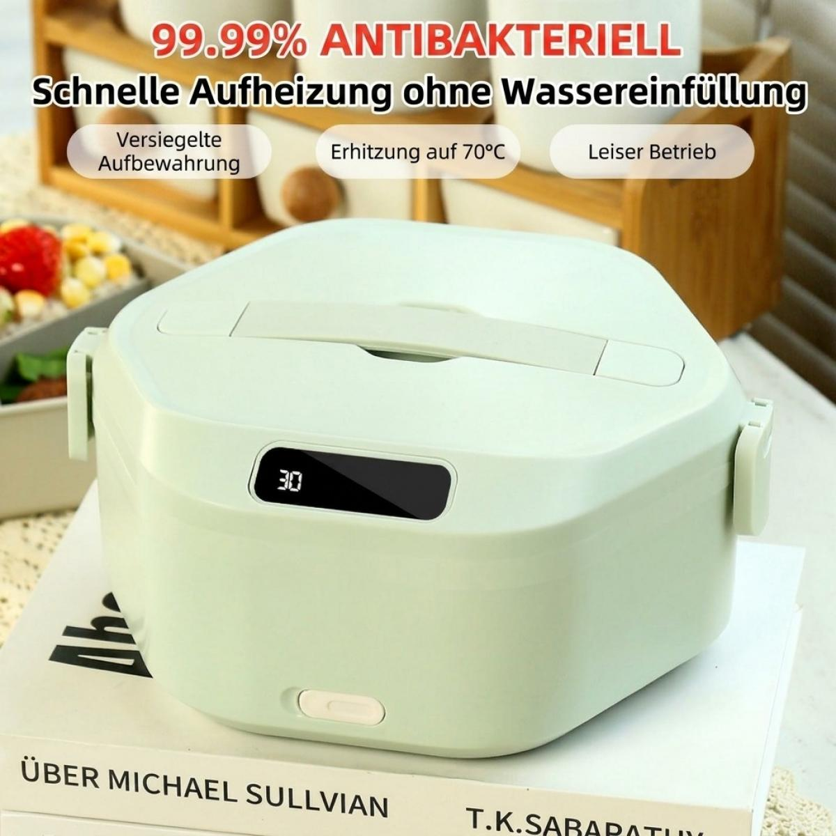 Eine hellgrüne elektrische Lunchbox steht auf Büchern mit deutschem Infotext.