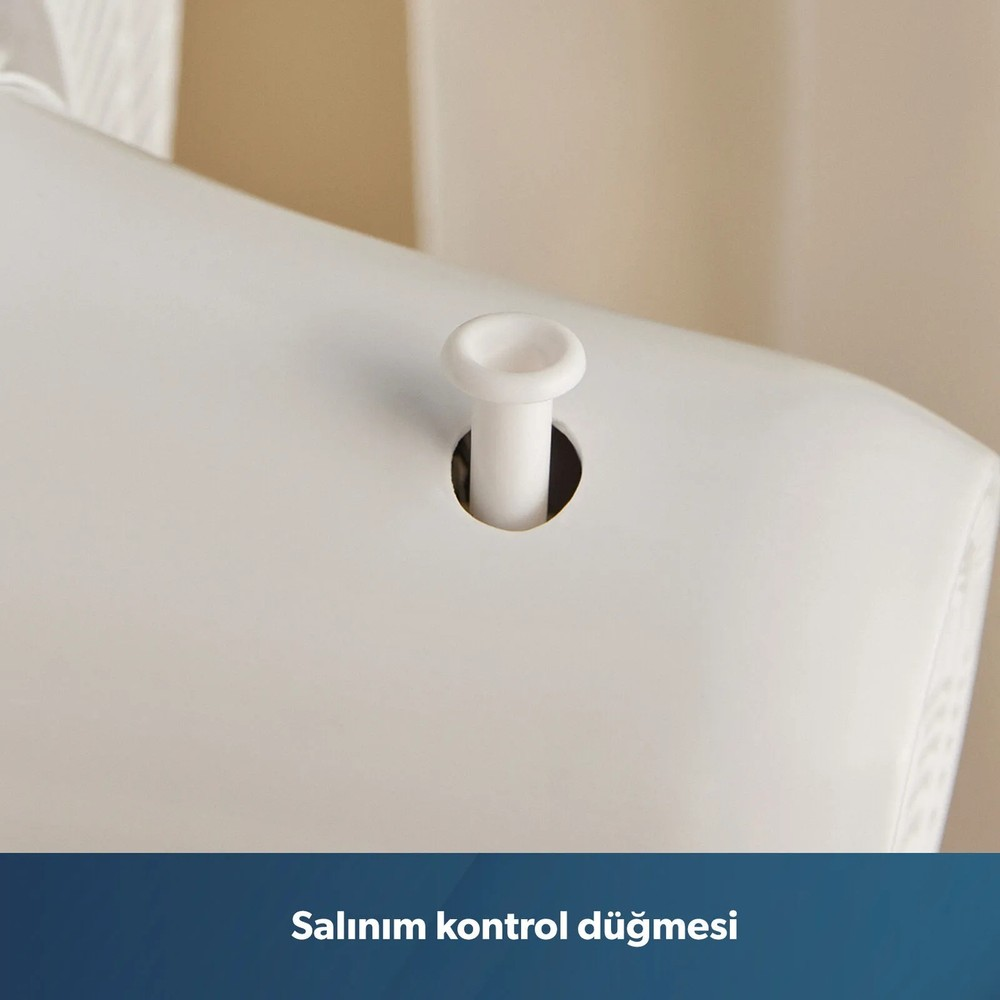 Beyaz bir cihaz yüzeyi üzerindeki beyaz salınım kontrol düğmesinin yakın plan görüntüsü.