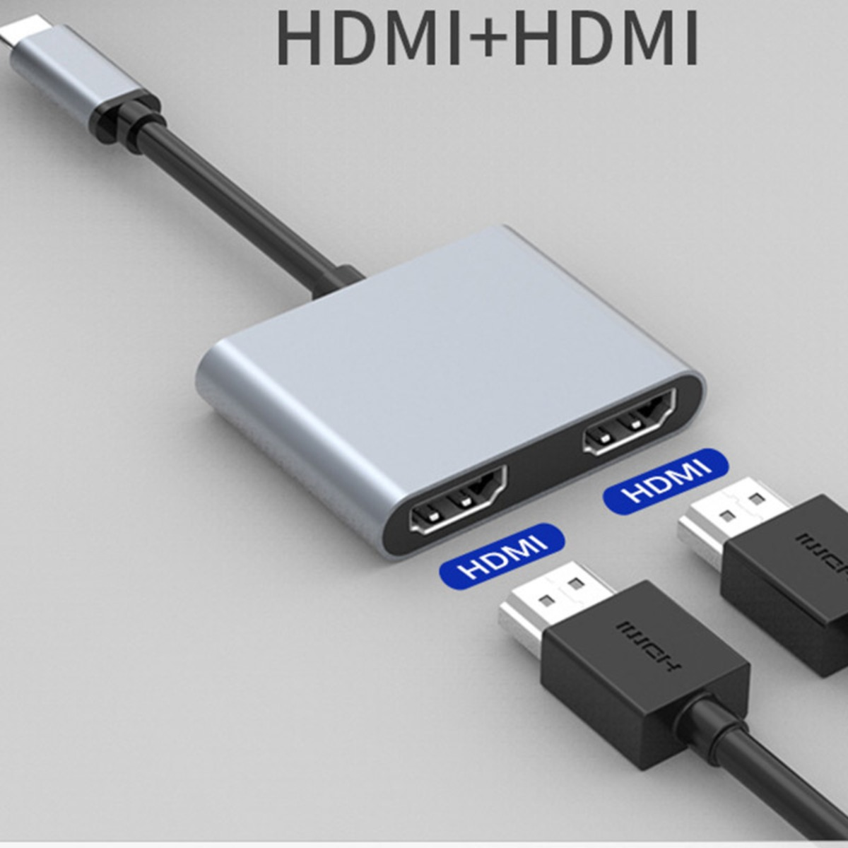Srebrny rozgałęźnik HDMI na dwa porty HDMI z podłączonymi kablami.