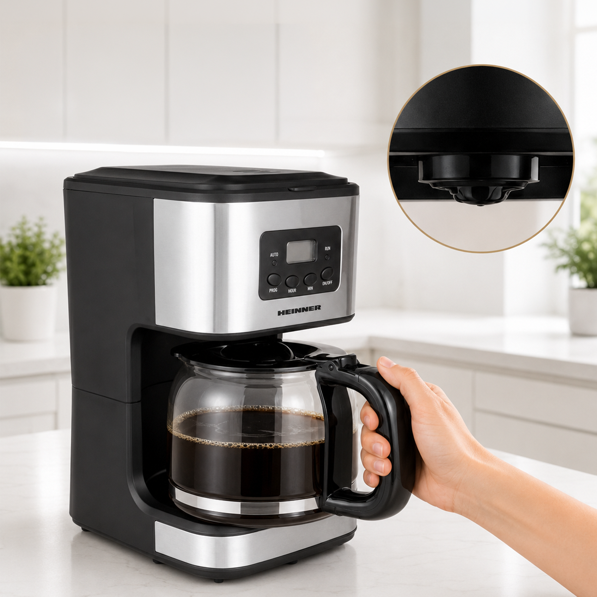 Une personne tient une cafetière en verre remplie de café devant une cafetière filtre moderne noire et argentée.