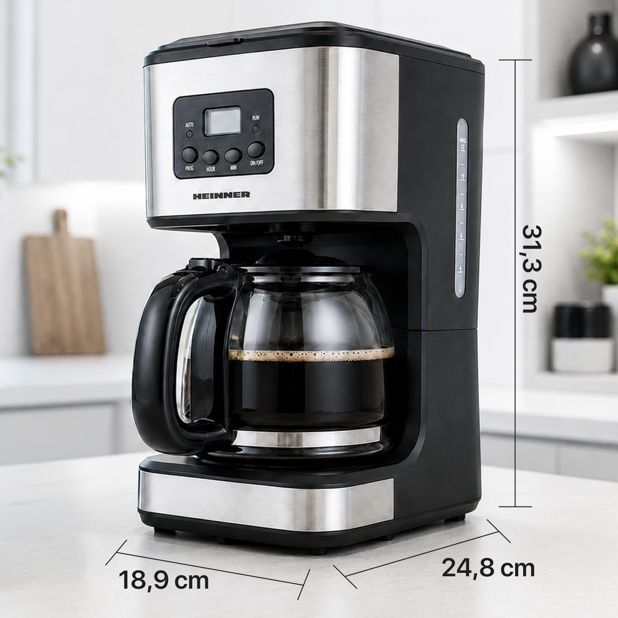 A black and silver Heinner drip coffee maker with glass carafe on a white counter, showing dimensions.