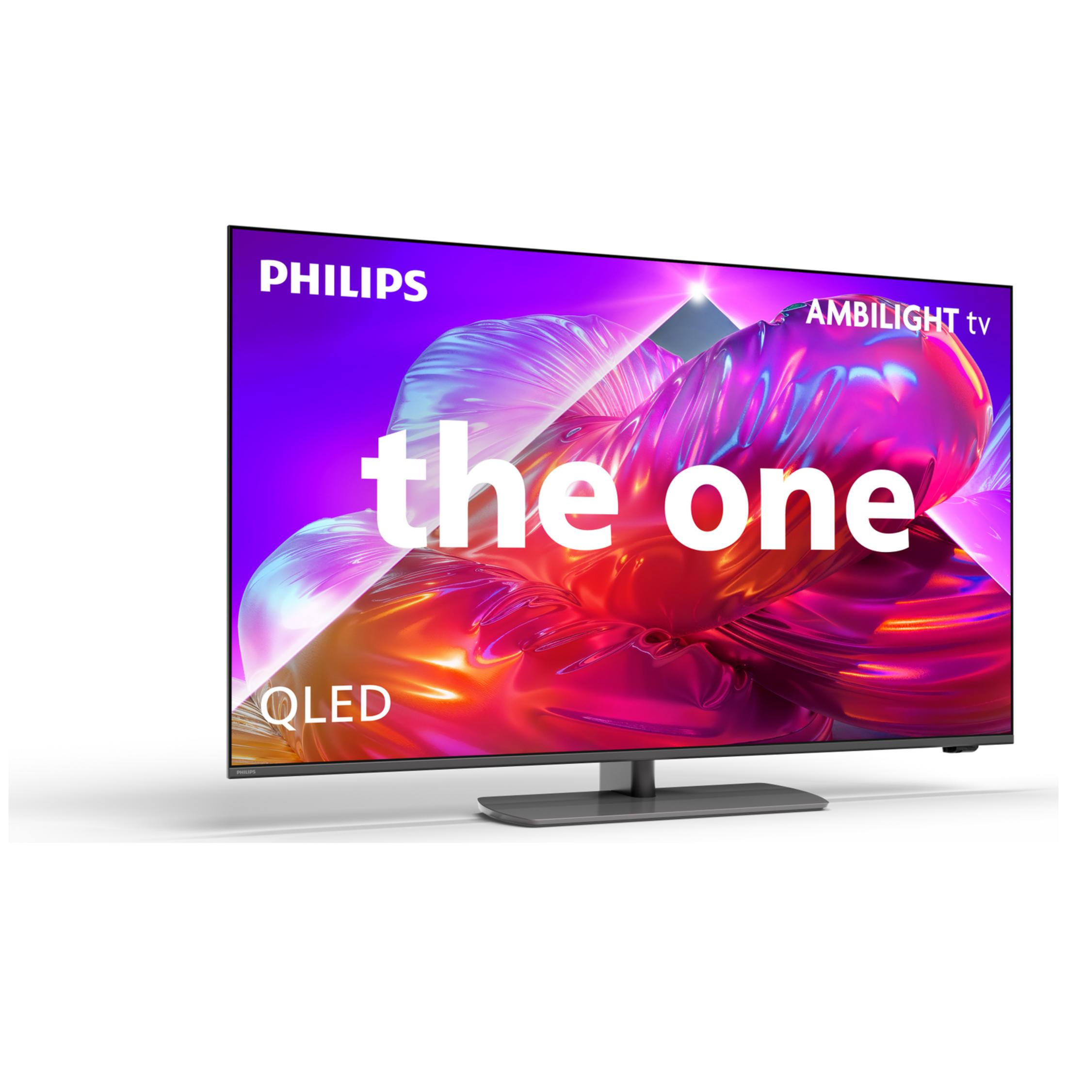 Telewizor Philips Ambilight QLED na stojaku przedstawiający kolorowy abstrakcyjny obraz z napisem "the one".