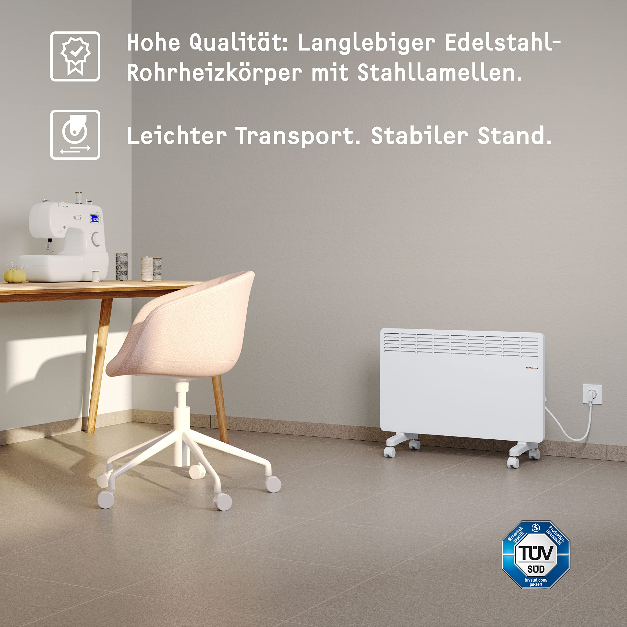 Ein weißer Elektroheizer auf Rädern steht in einem Raum mit rosa Stuhl, Schreibtisch und Text oben.