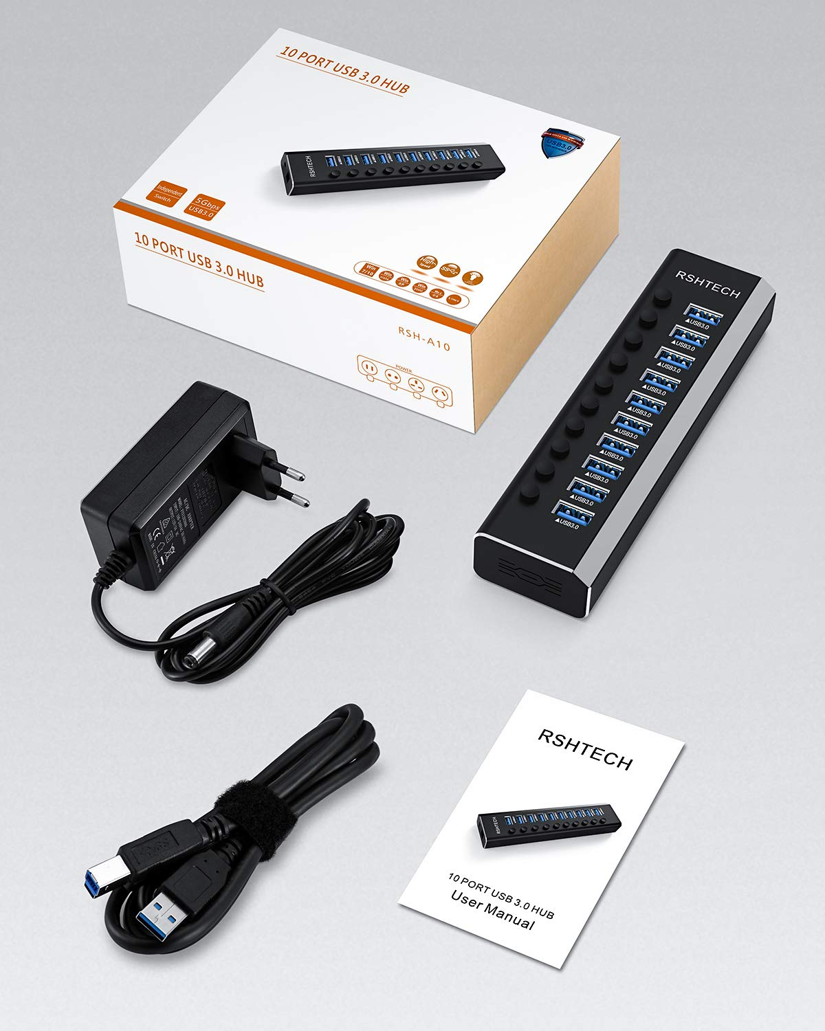 Ein 10-Port-USB-3.0-Hub in einer Verpackung mit Netzteil, USB-Kabel und Handbuch.