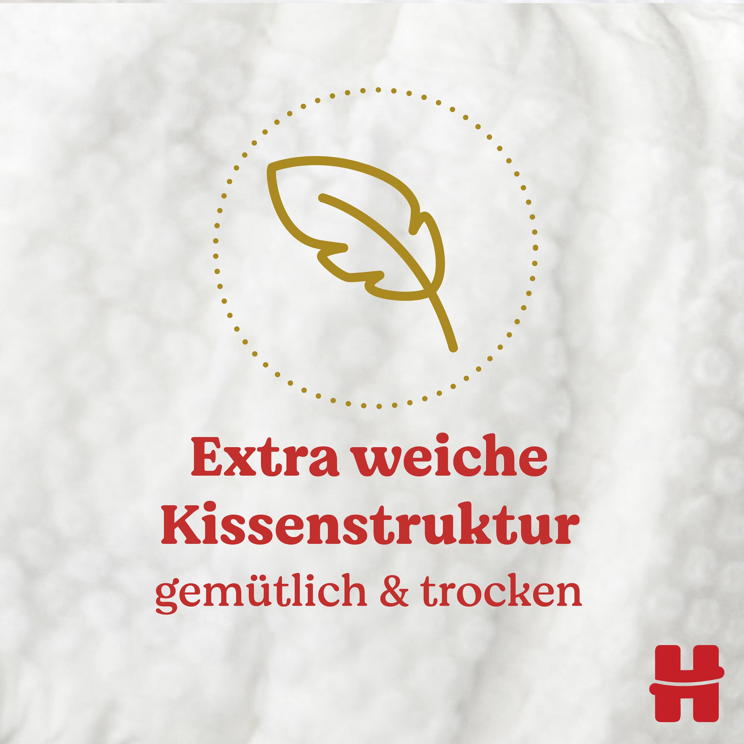 Goldenes Feder-Symbol in einem gepunkteten Kreis mit rotem Text "Extra weiche Kissenstruktur gemütlich & trocken".