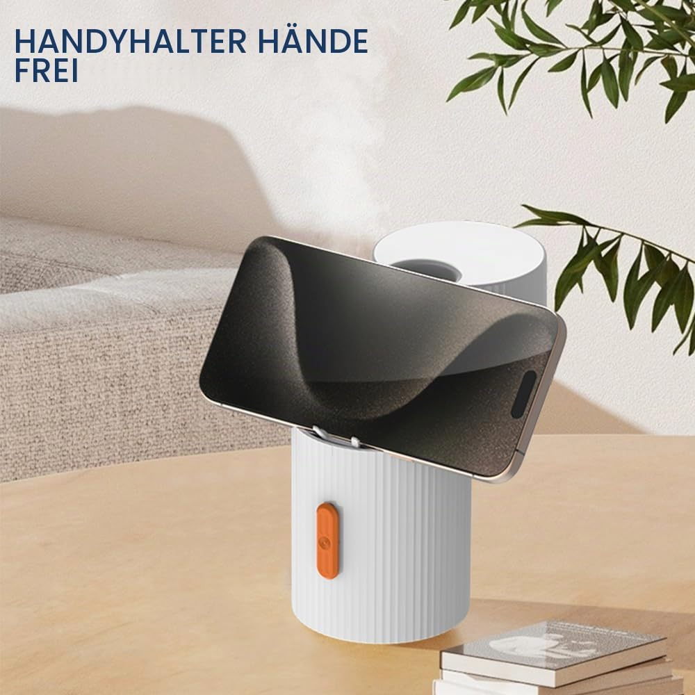 Ein weißer Zylinder-Handyständer mit orangefarbenem Knopf hält ein Smartphone auf einem Holztisch.