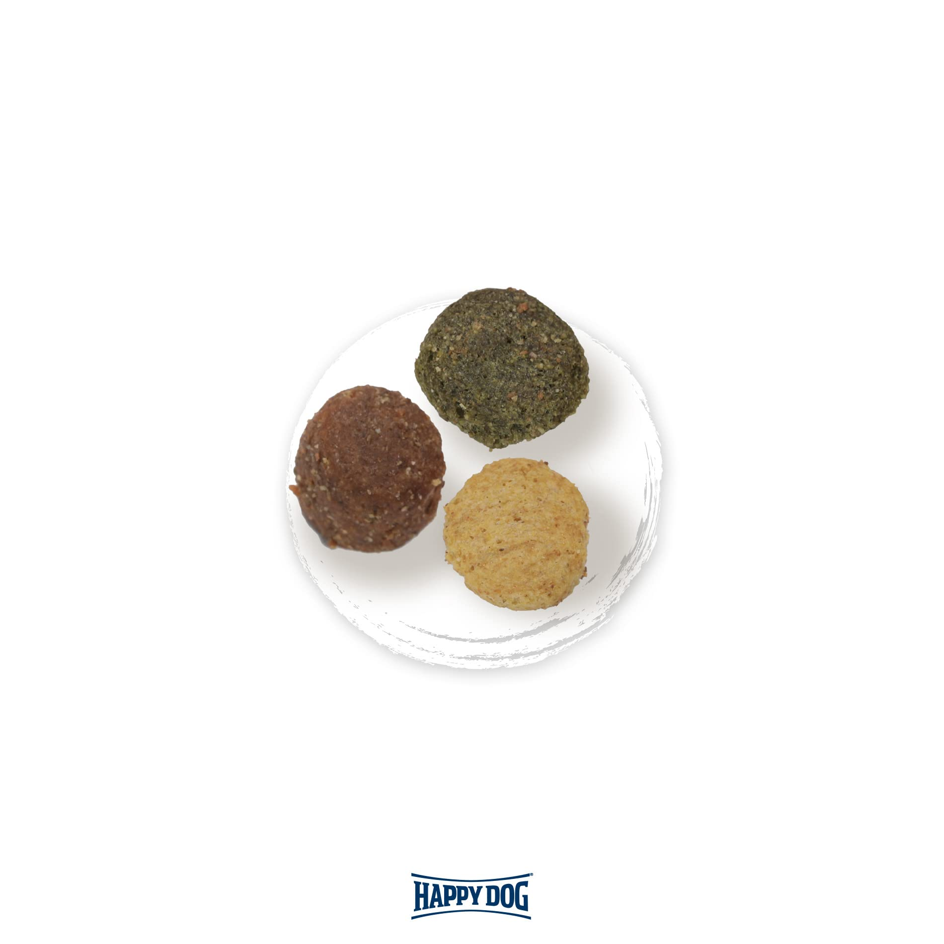 Drei runde Hunde-Snacks in Braun, Grün und Gelb liegen auf einem weißen Teller, unten das Happy Dog Logo.