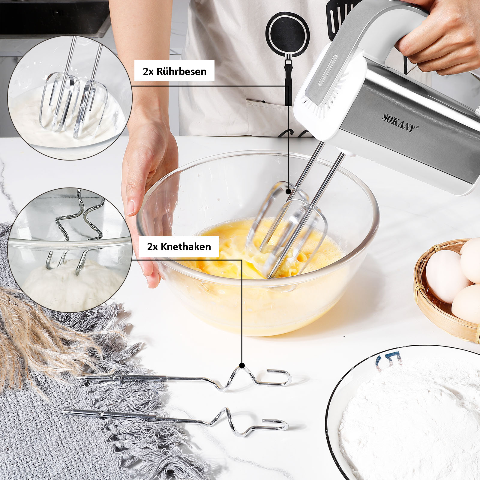 Handmixer mit Rührbesen und Knethaken, der Teig in einer Glasschüssel rührt, mit Eiern und Mehl auf dem Tisch.