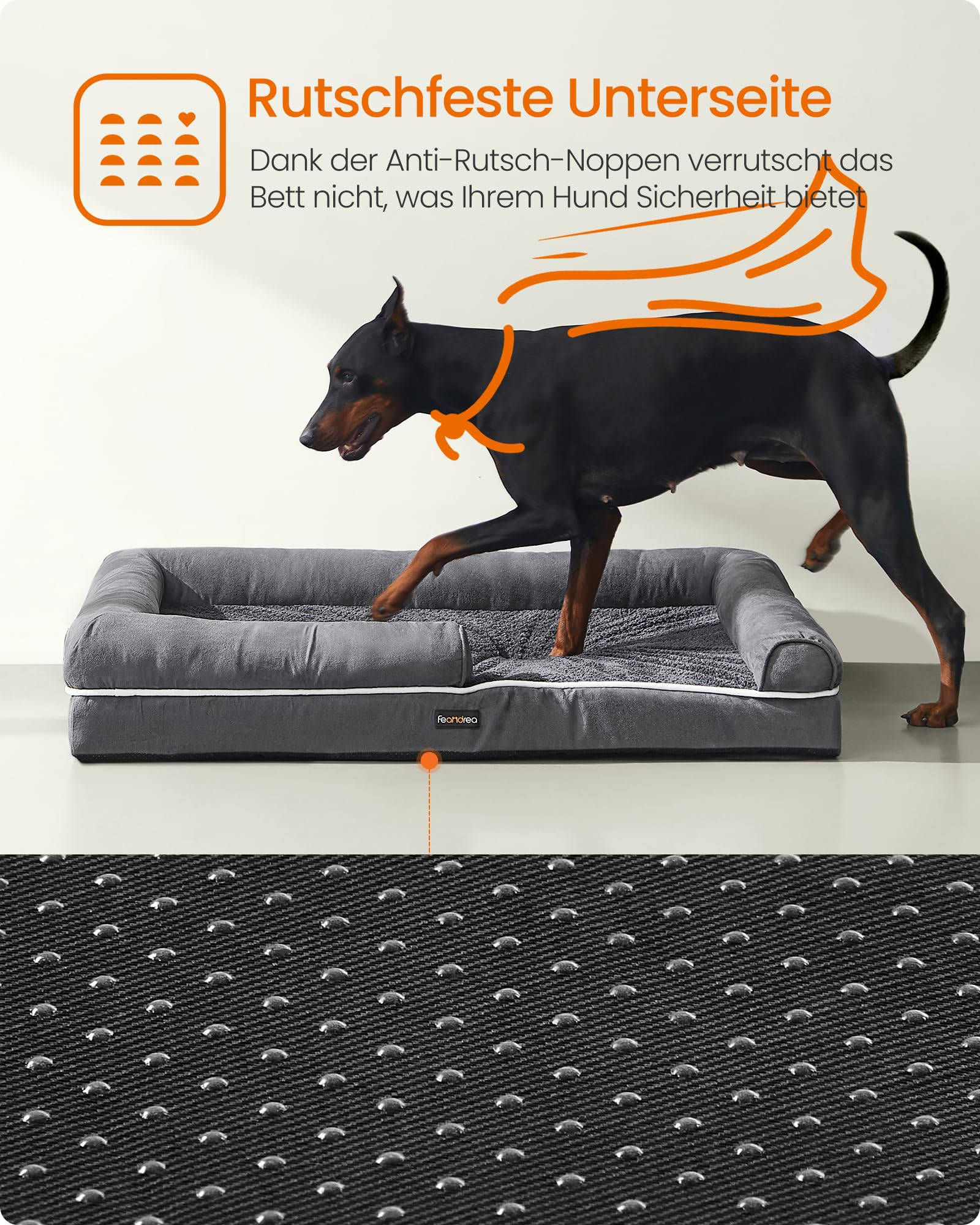 Un doberman saute par-dessus un lit pour chien gris à fond antidérapant.