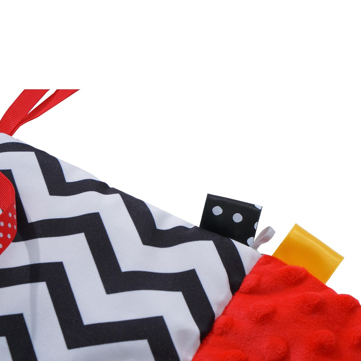 Ein Babybuch mit schwarz-weißen Zickzackmustern, rotem gepunktetem Stoff und bunten Etiketten.