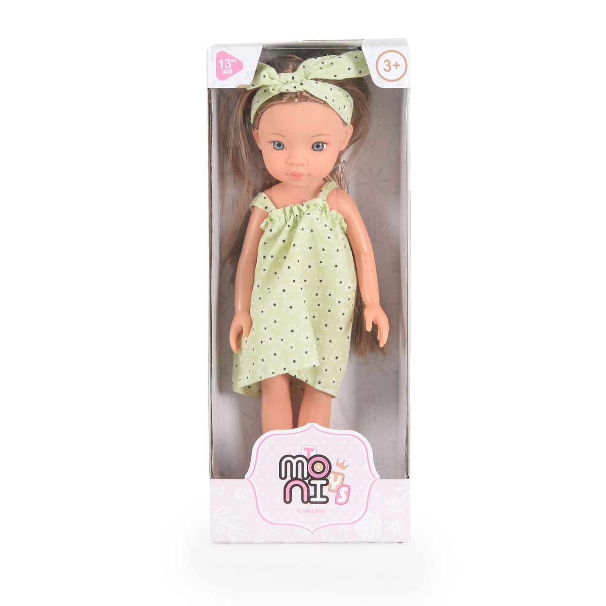 Eine 33 cm große Puppe in einer Schachtel, mit grünem Musterkleid und Haarband.