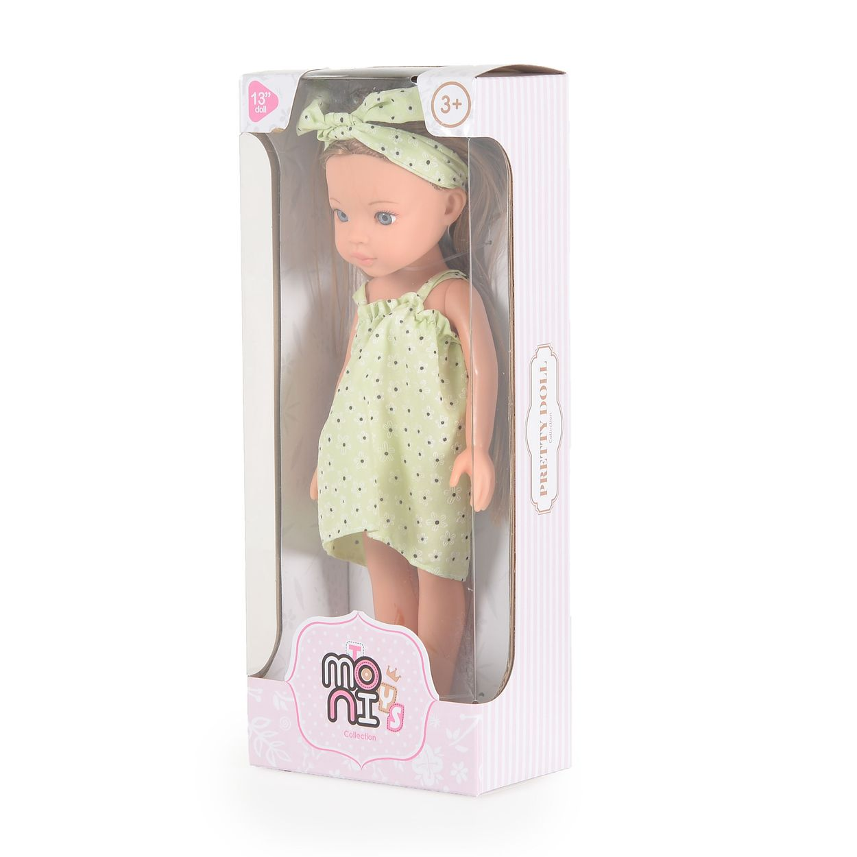 Eine Puppe mit langem Haar und grünem Blumenkleid steht in einer rosa-weißen Verpackung.