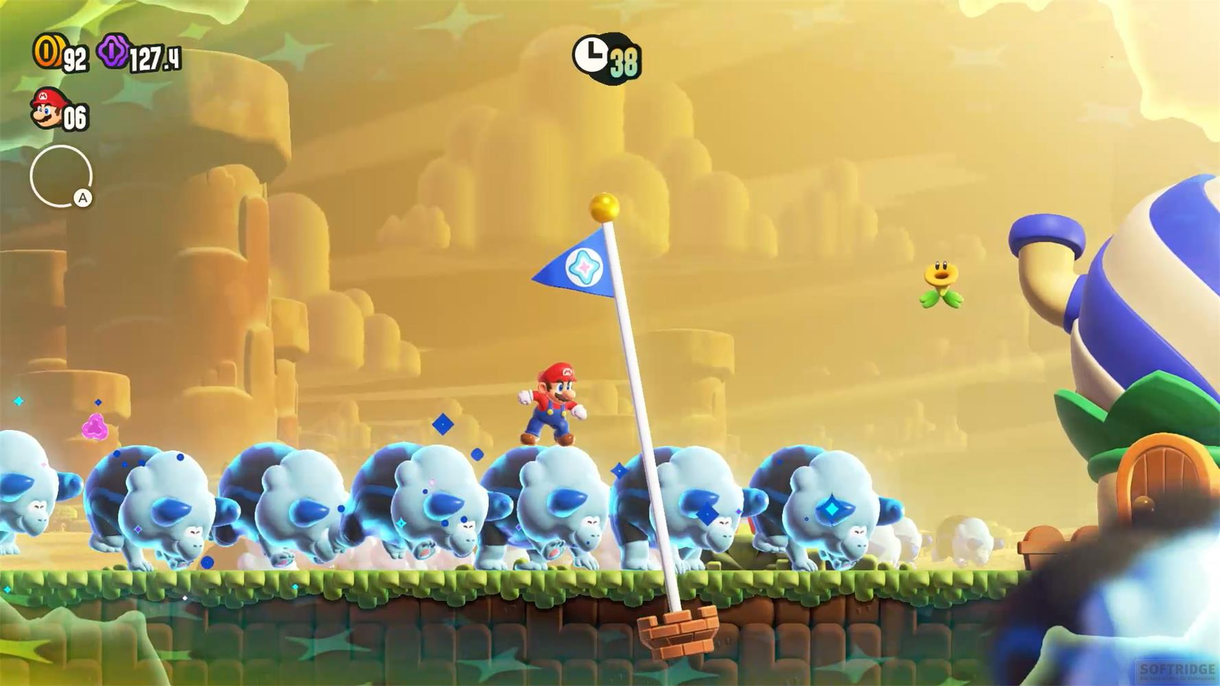 Mario reitet auf einer Gruppe blauer Nashorn-Wesen vor einer gelben Canyon-Kulisse in Super Mario Bros. Wonder.