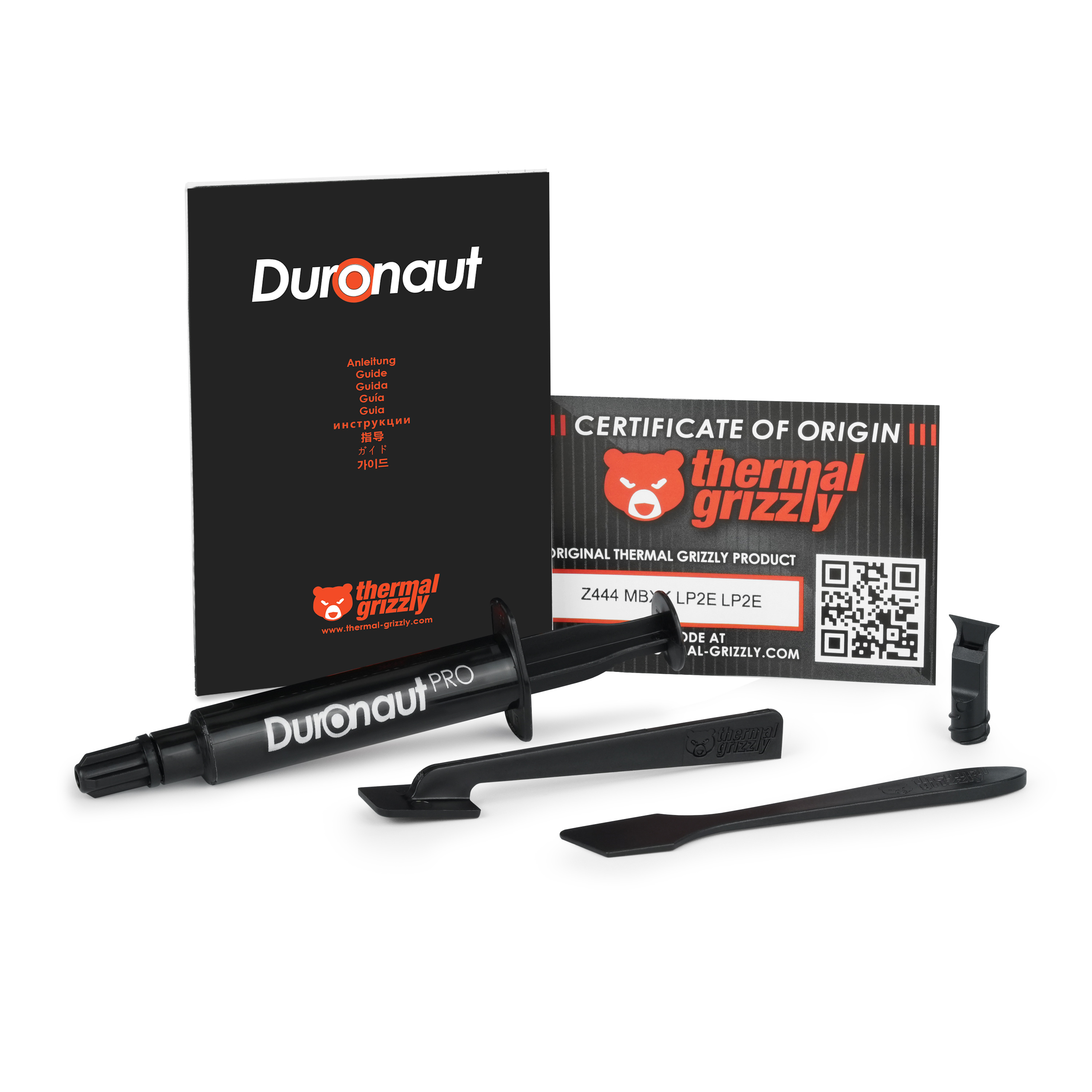 Duronaut Pro Wärmeleitpaste Kit mit Spritze, Anleitungsheft, Zertifikat und zwei Applikatoren auf weißem Grund.