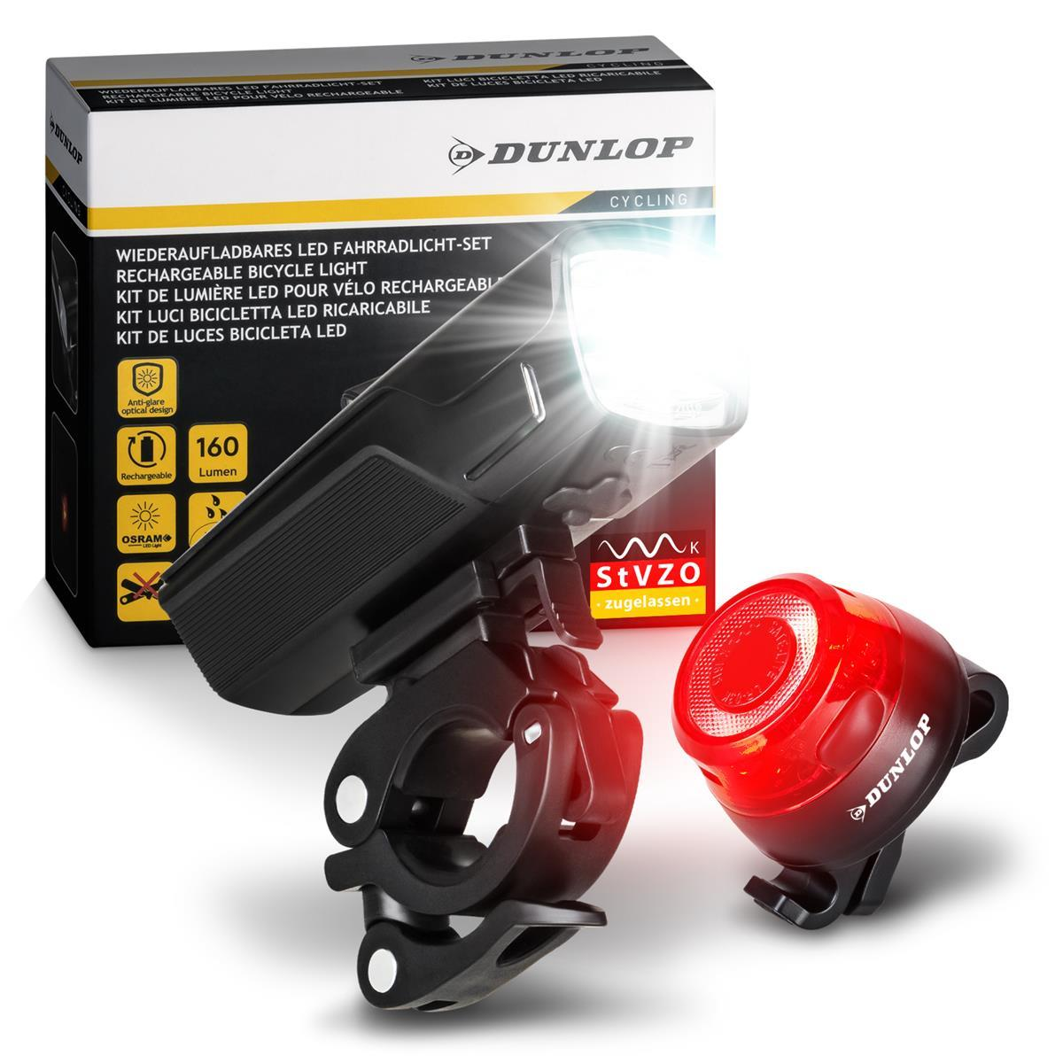 Ein wiederaufladbares Dunlop LED-Fahrradlichtset vor seiner Produktverpackung mit hellem Front- und rotem Rücklicht.