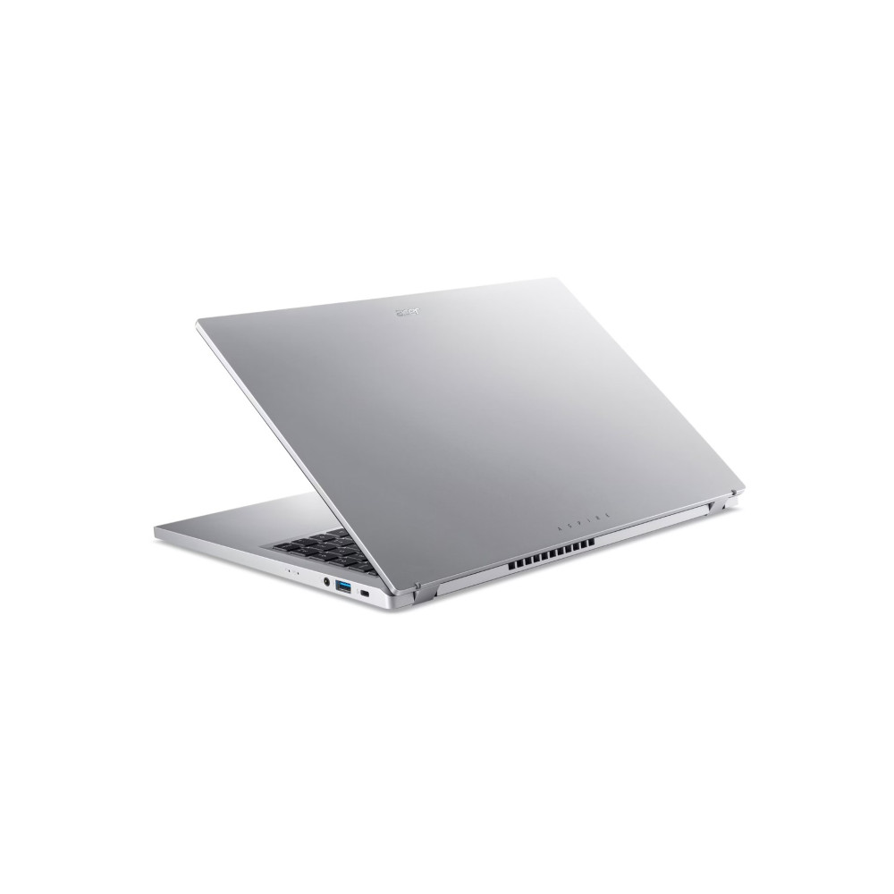 Srebrny laptop, częściowo zamknięty, z widoczną klawiaturą i portami na białym tle.