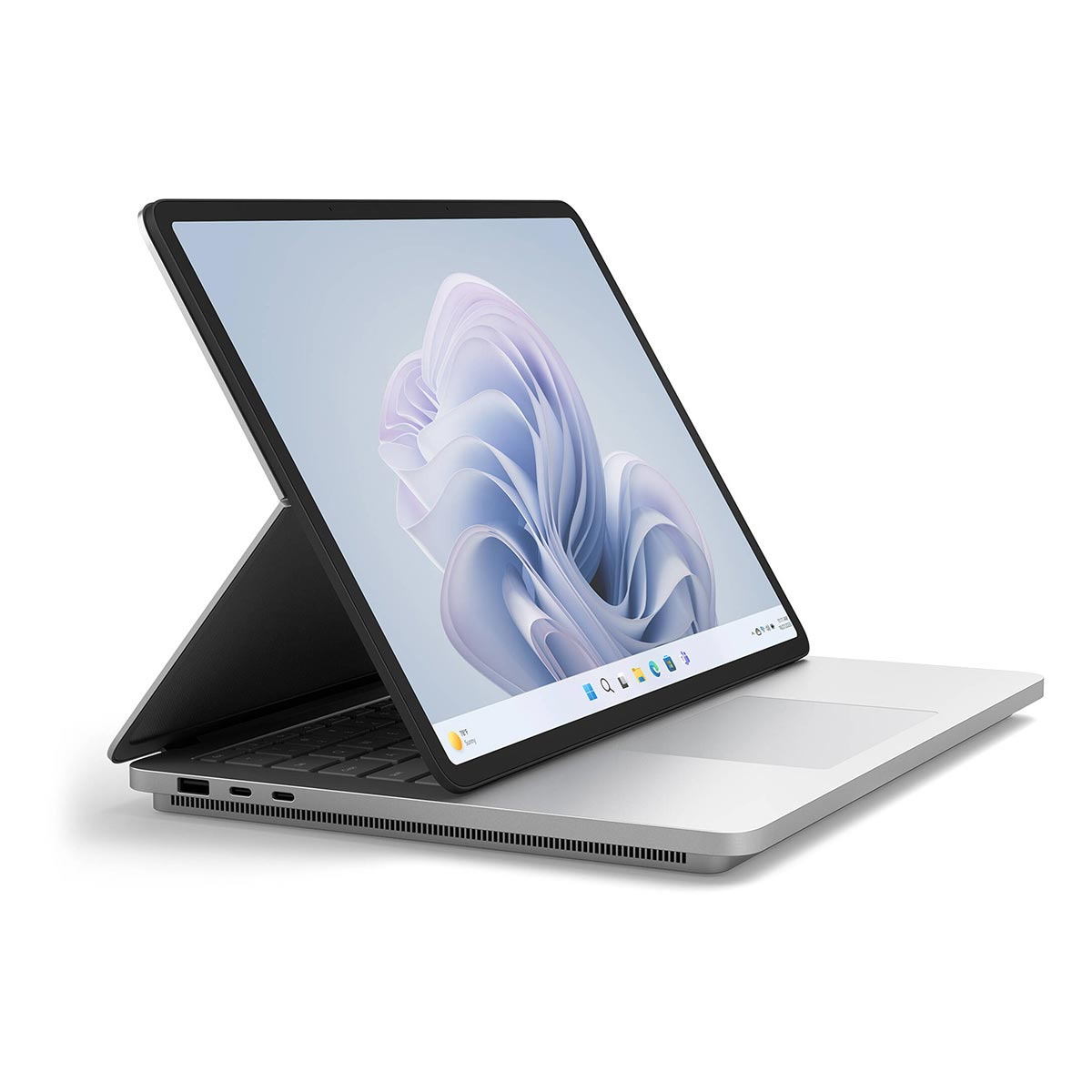 Srebrny laptop z odłączanym ekranem wyświetla abstrakcyjną tapetę na białej powierzchni.