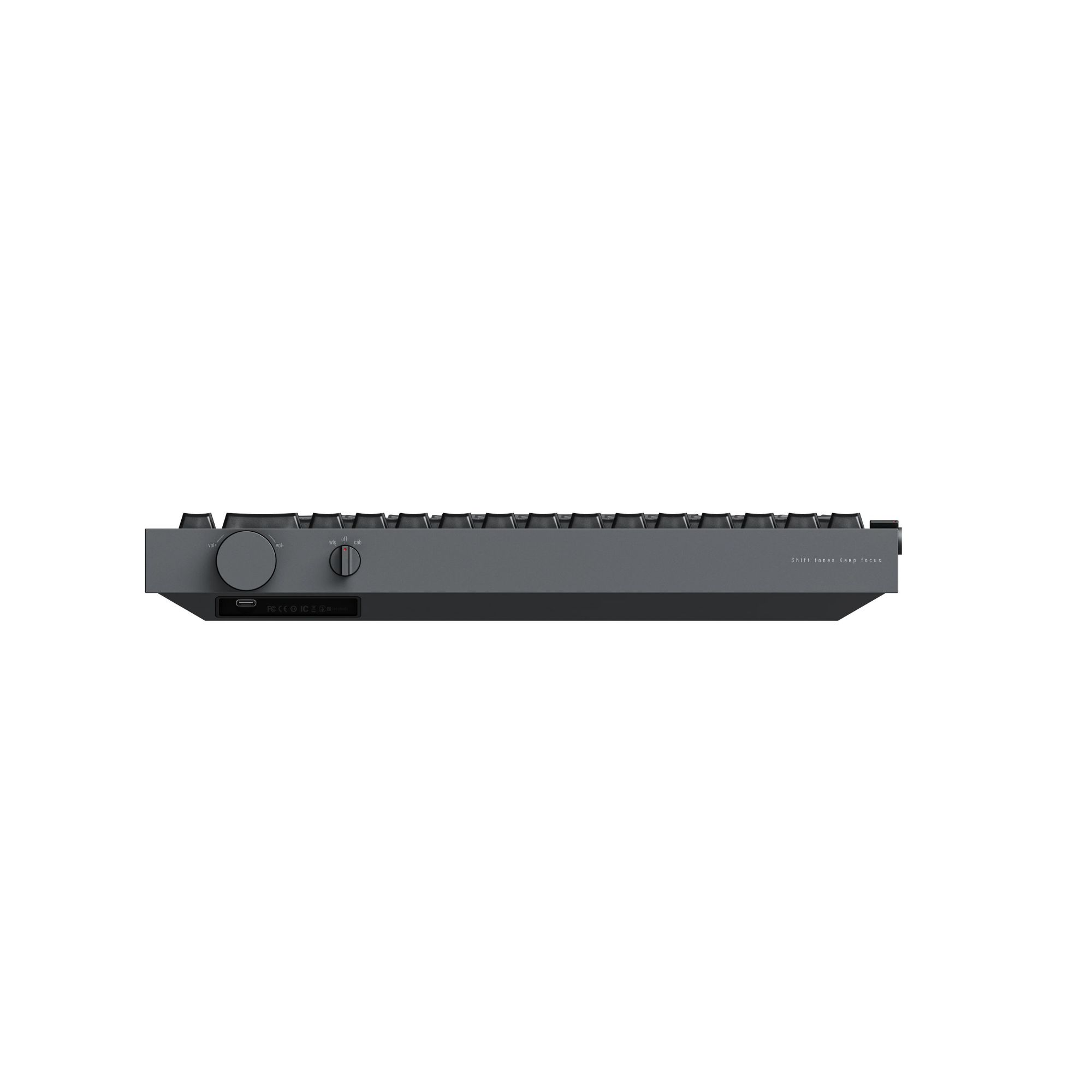 Ciemnoszara klawiatura widziana z przodu, z pokrętłem głośności, przełącznikiem, portem USB-C i napisem Shift tones Keep focus.