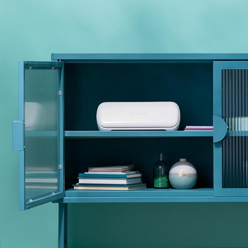Un meuble en métal bleu avec des portes vitrées contient un appareil blanc en haut et des livres et vases en bas.