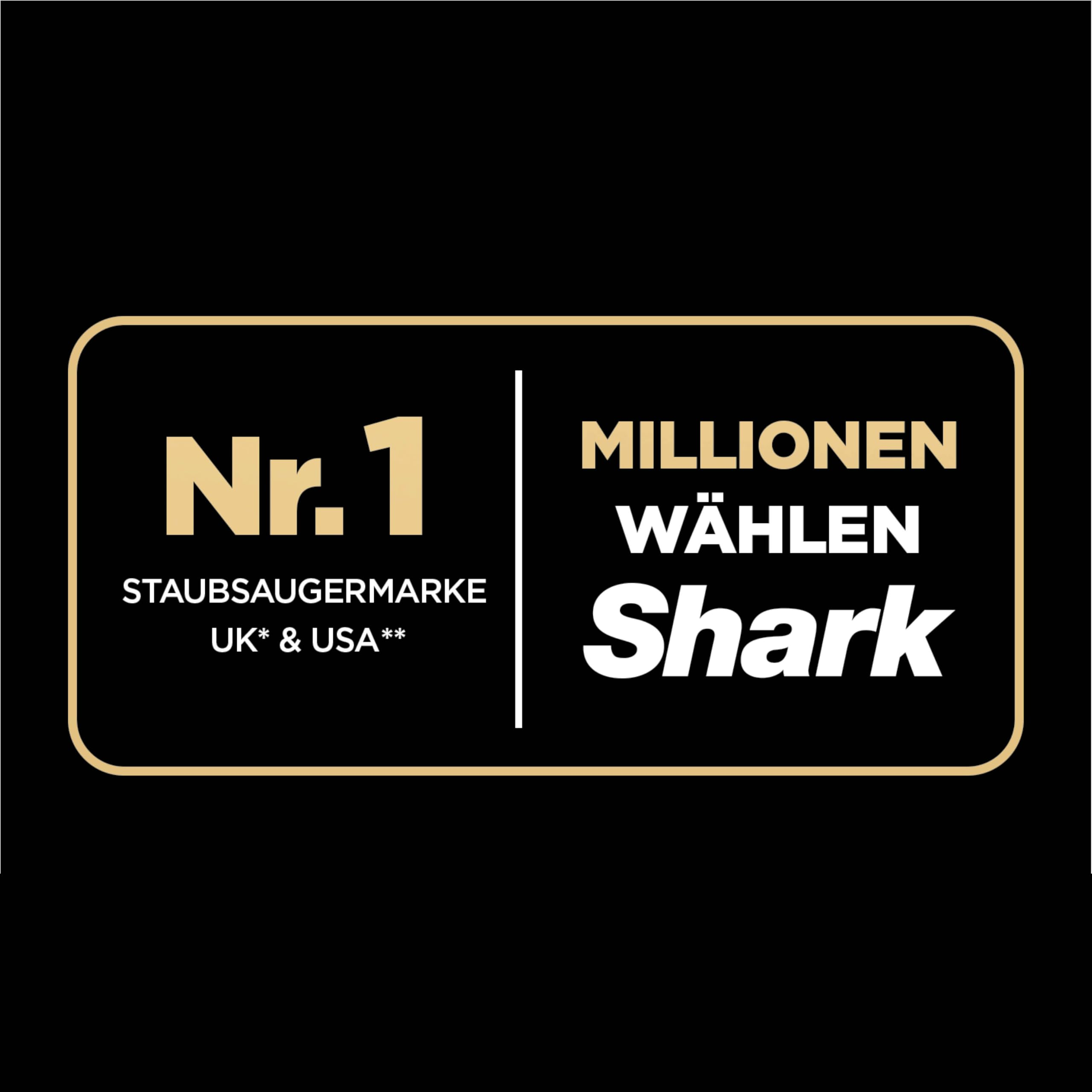 Insegna pubblicitaria oro e bianco per il marchio di aspirapolvere Shark su sfondo nero.