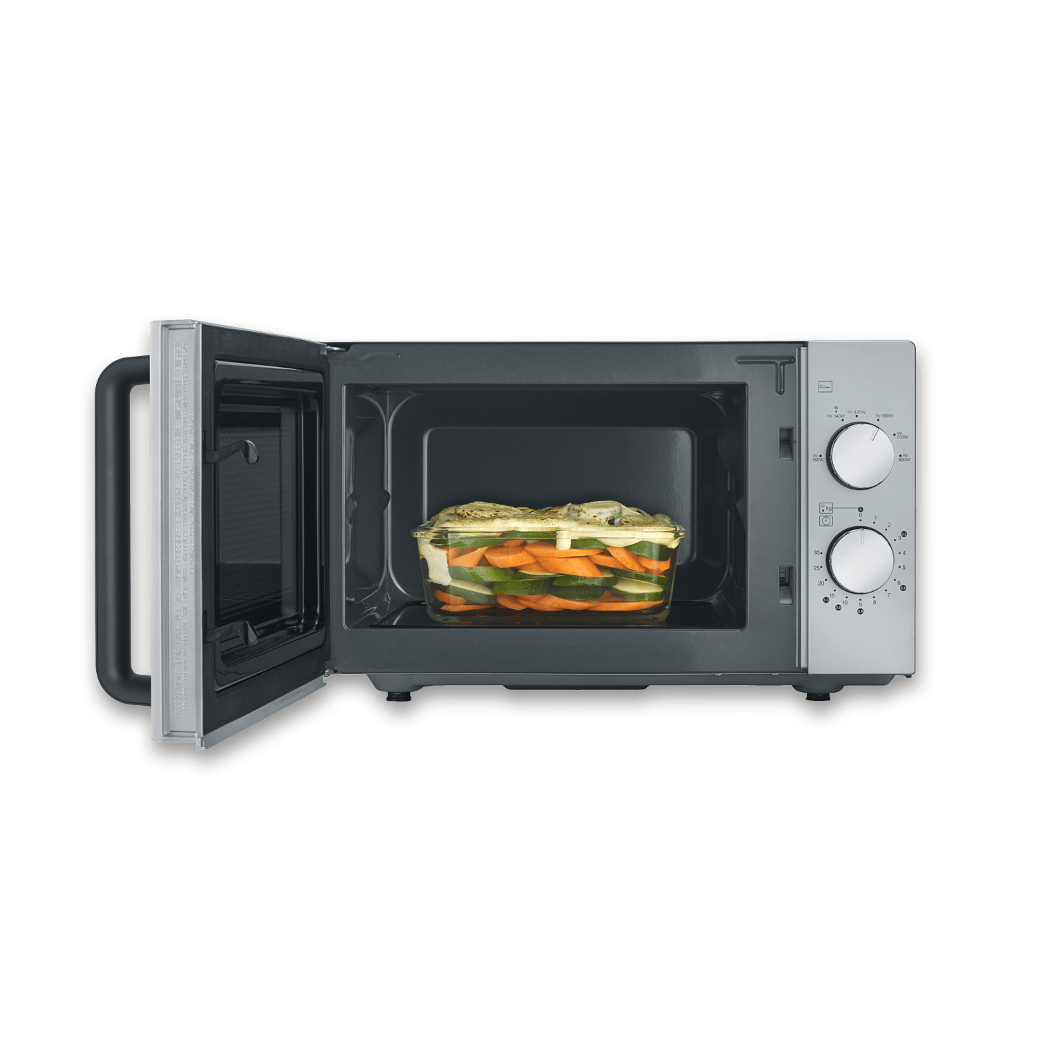 Un microonde aperto con una pirofila di carote, zucchine e formaggio.