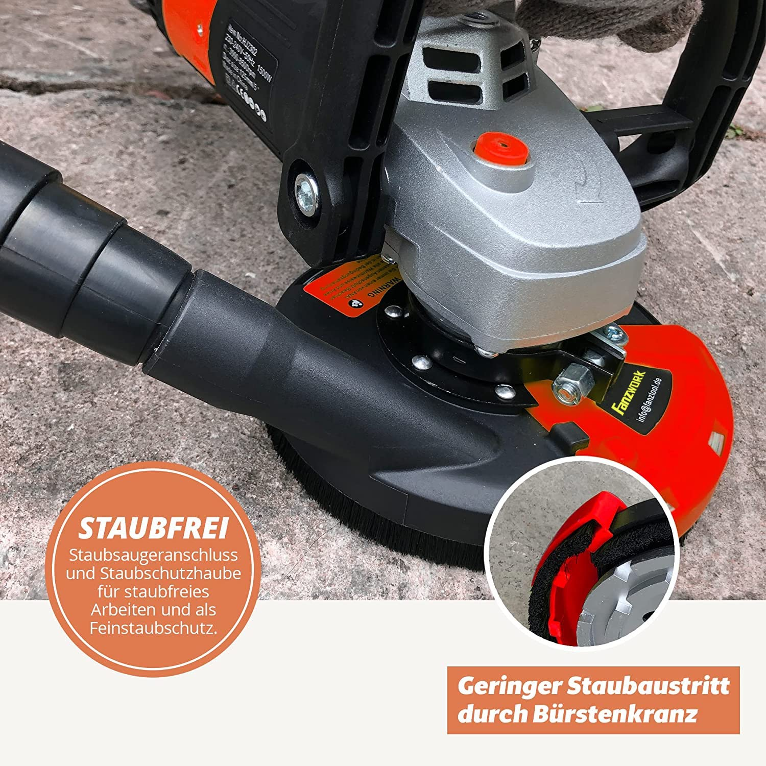 Winkelschleifer mit Staubabsaugung auf grauem Boden, Nahaufnahme.
