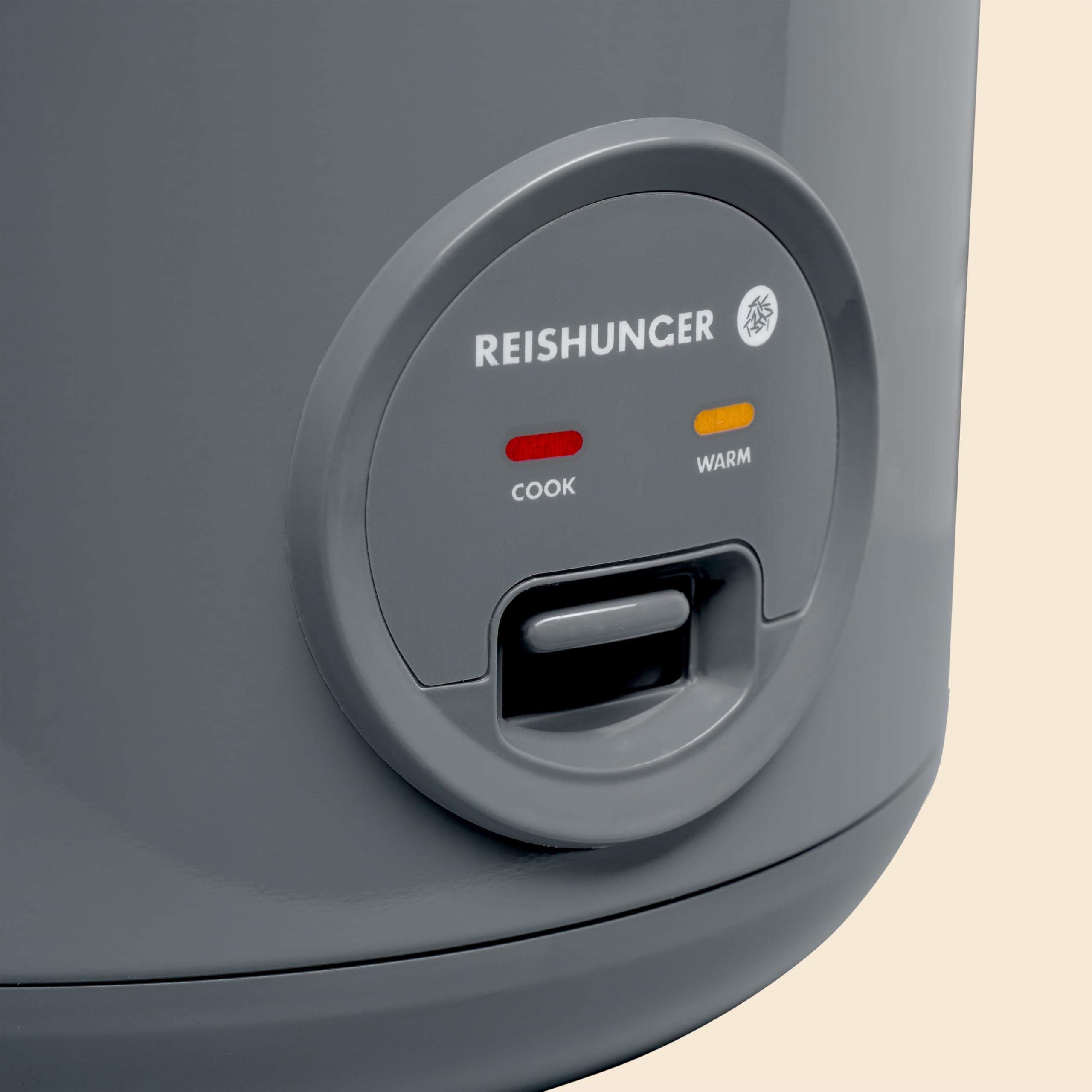 Grauer Reishunger Reiskocher mit Bedienfeld, roter Koch- und gelber Warmhalteleuchte.