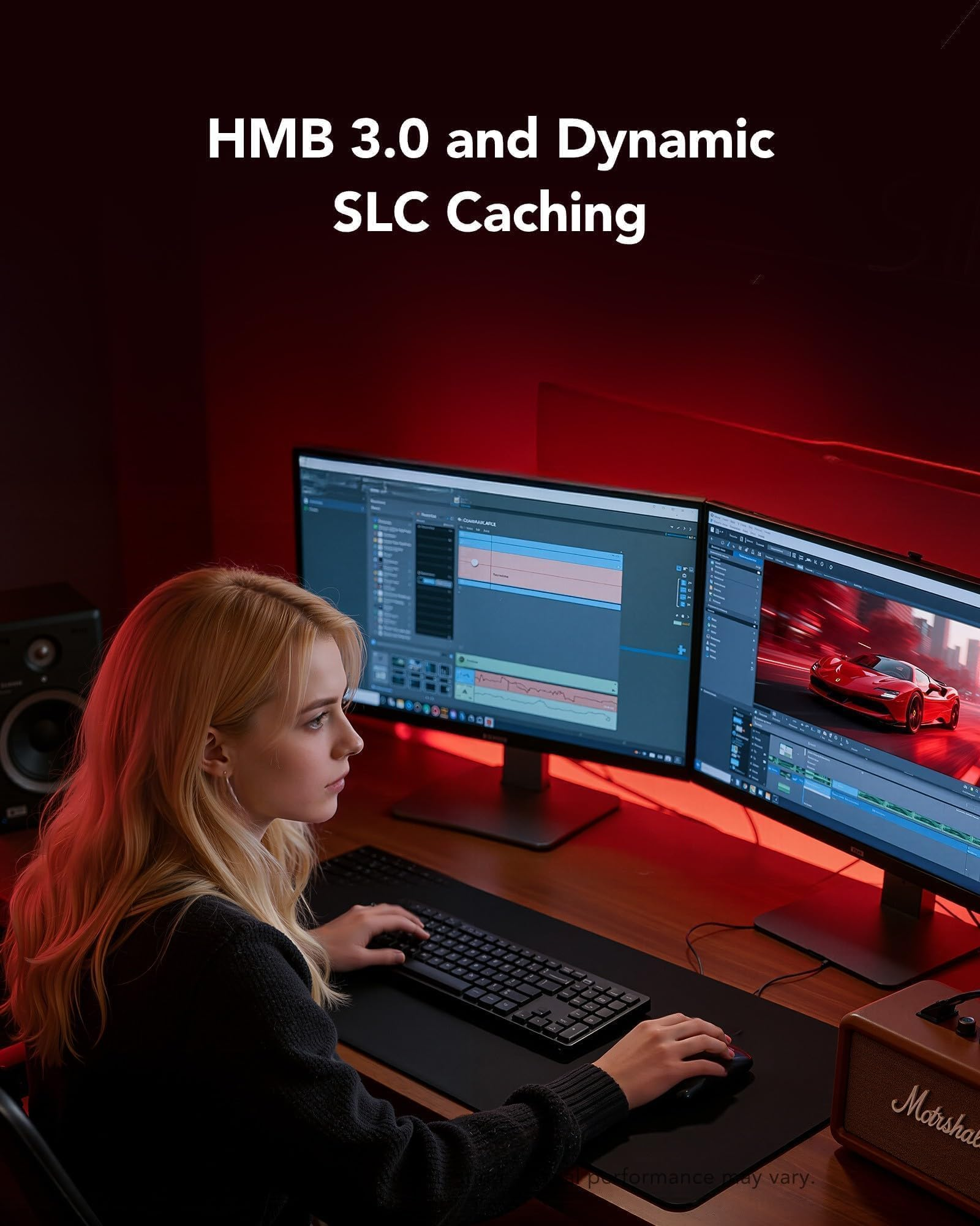 Una donna bionda lavora su due monitor in una stanza rosso scuro, montando video.