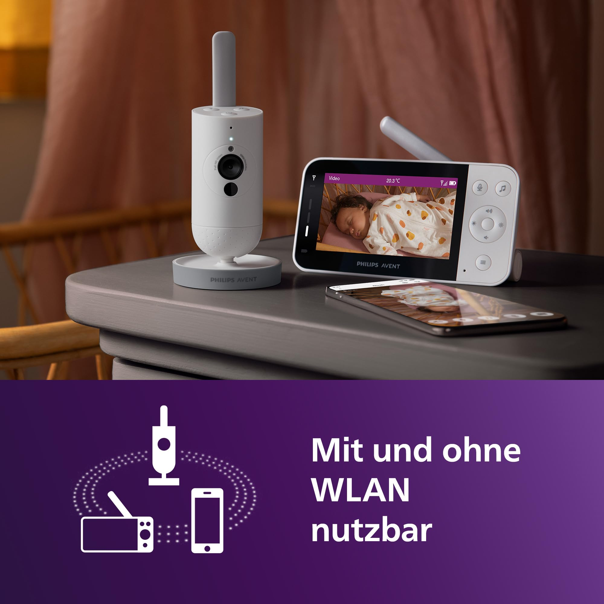 Écoute-bébé Philips Avent avec caméra, unité parents et smartphone sur une table, texte en bas.