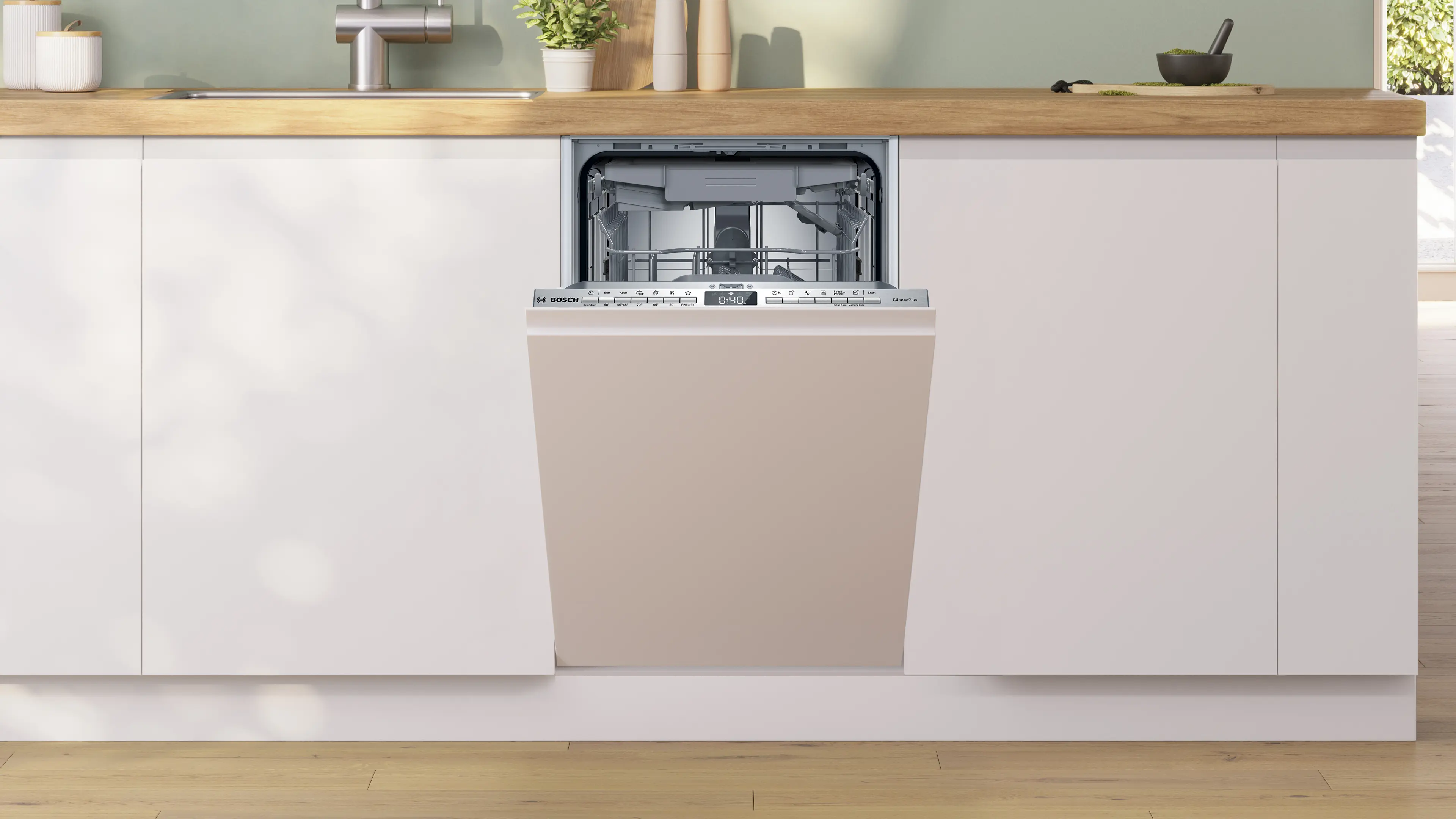 Una lavastoviglie da incasso Bosch è mezza aperta in una cucina moderna con mobili bianchi e piano in legno.