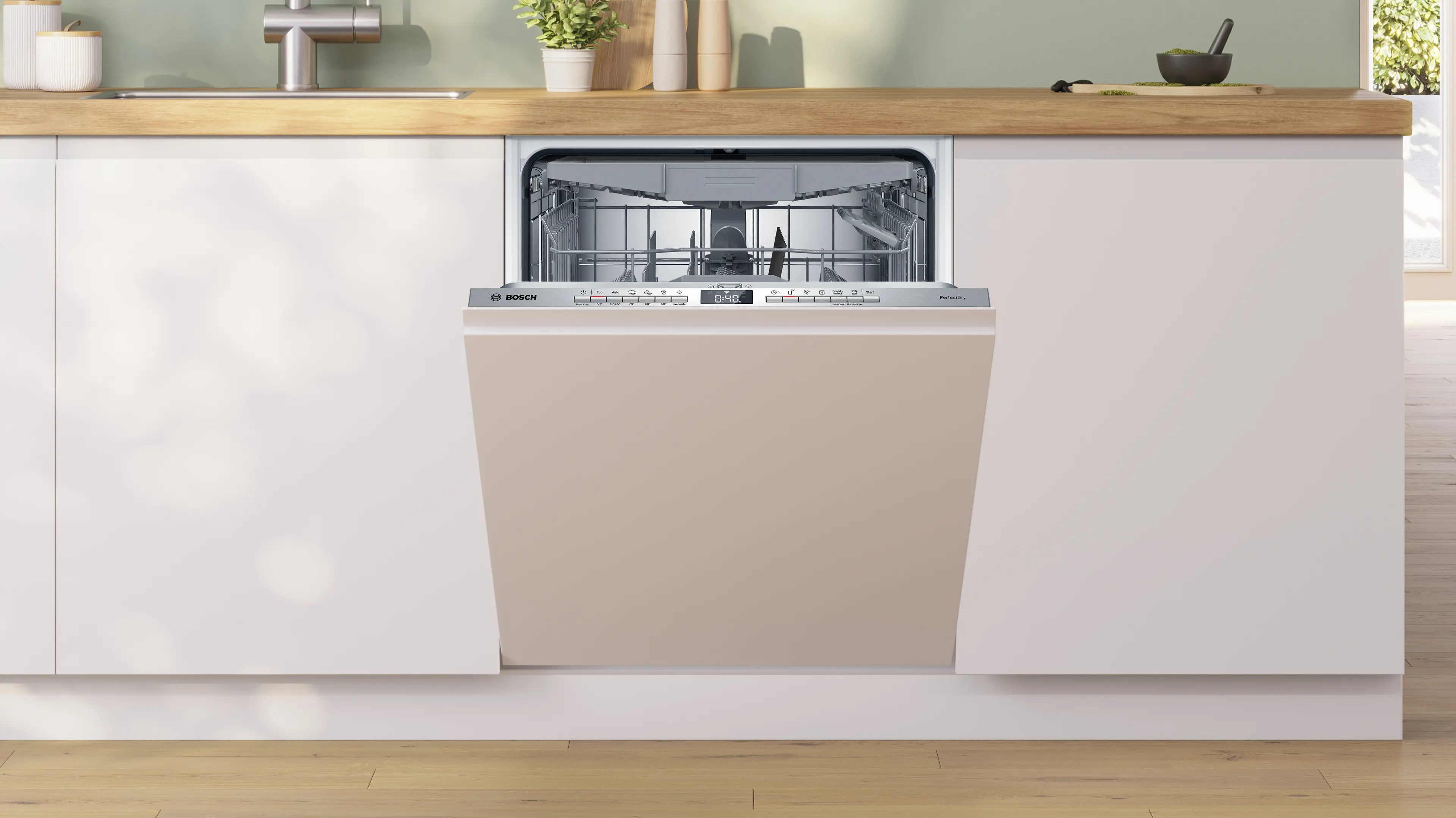 Una lavastoviglie aperta color beige in una cucina moderna con piano di lavoro in legno.