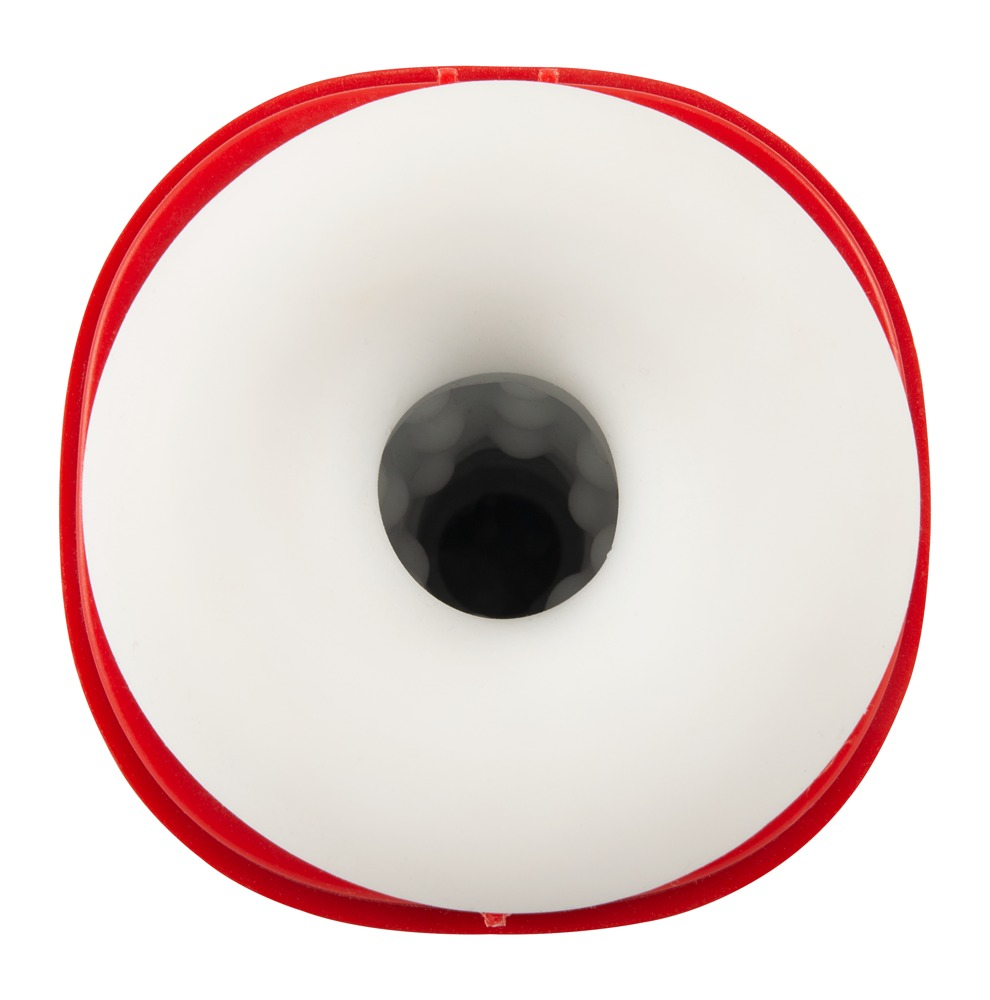 Top-down view of a red circular device with a white inner ring and a textured dark central opening.