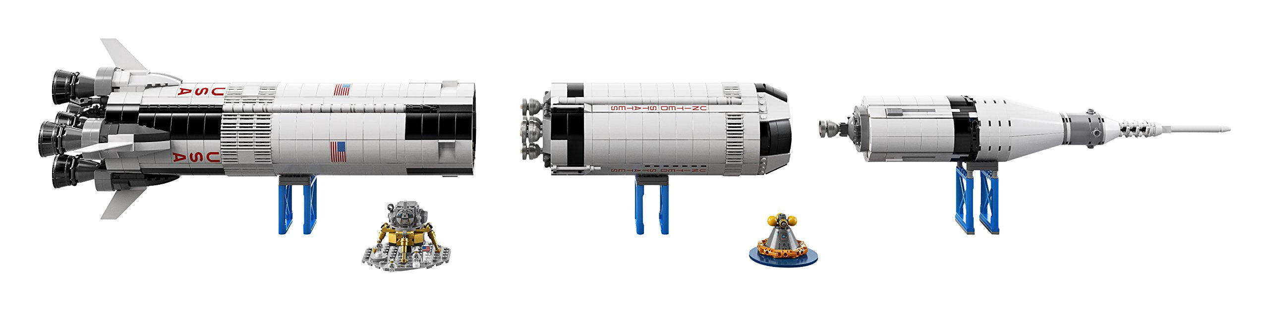 Un modèle de fusée Lego Saturn V démonté avec des étages séparés et de petits engins spatiaux sur des supports bleus.