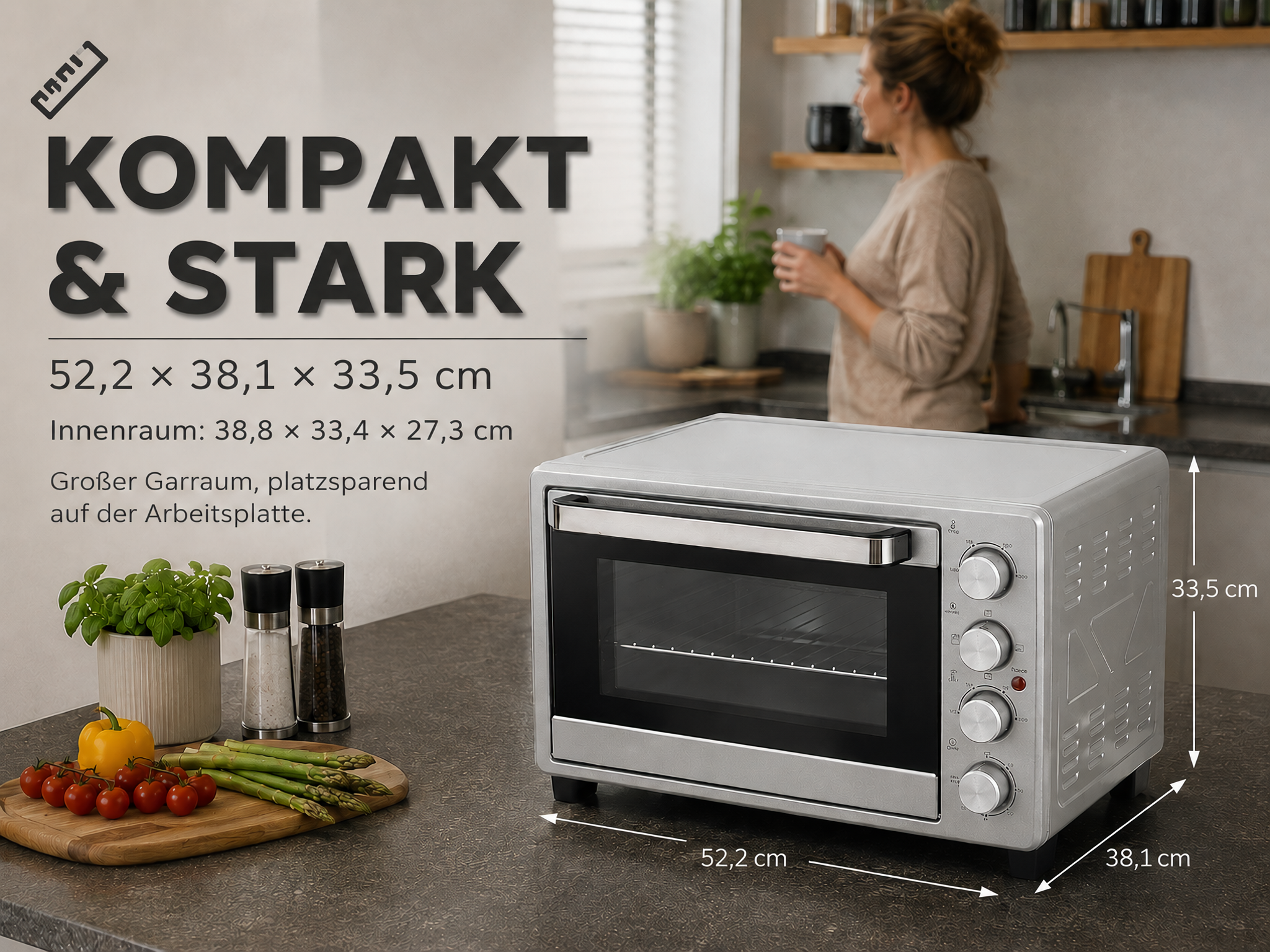 Ein silberner Mini-Backofen auf einer Küchenarbeitsplatte mit Maßen und Text.