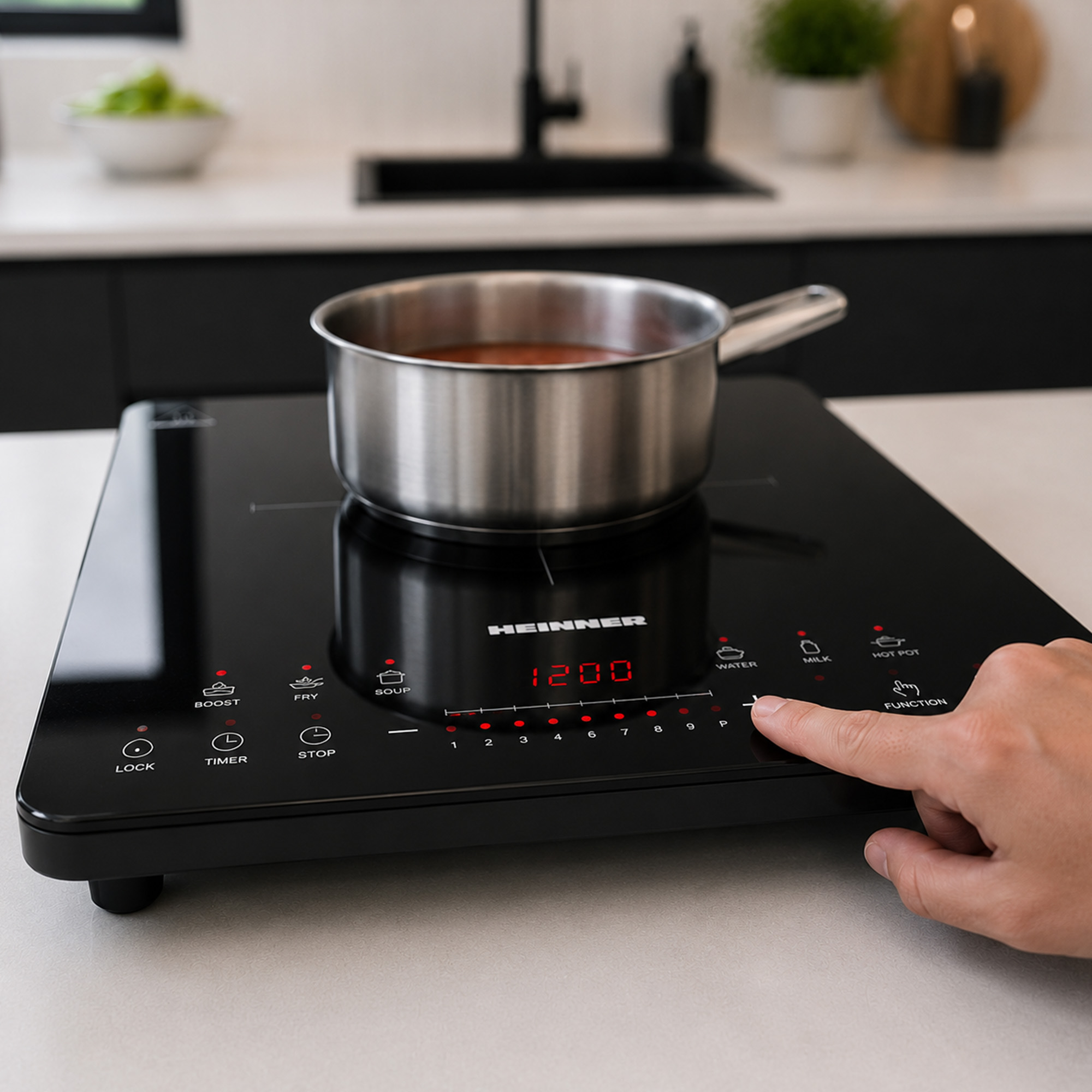 Hand pressing plus button on black induction cooktop with pot.