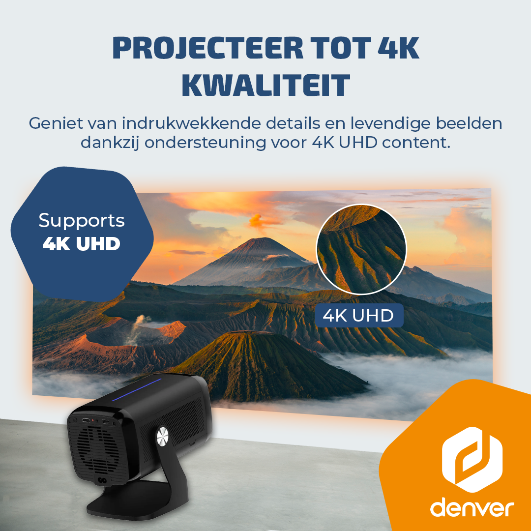 A black projector on a surface, projecting a vibrant mountain landscape with 4K UHD resolution.
