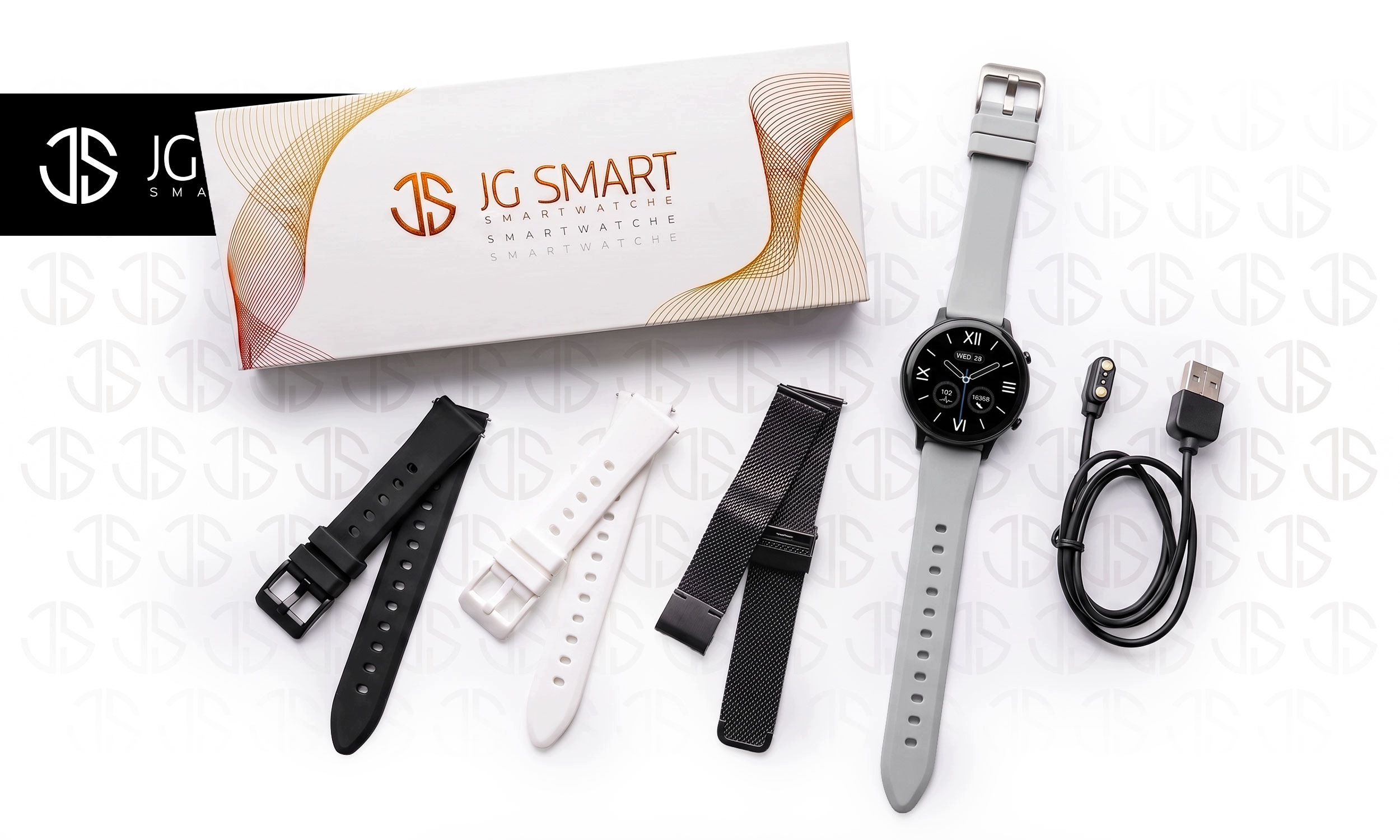 Smartwatch JG w pudełku z szarym, białym i czarnym paskiem oraz kablem.
