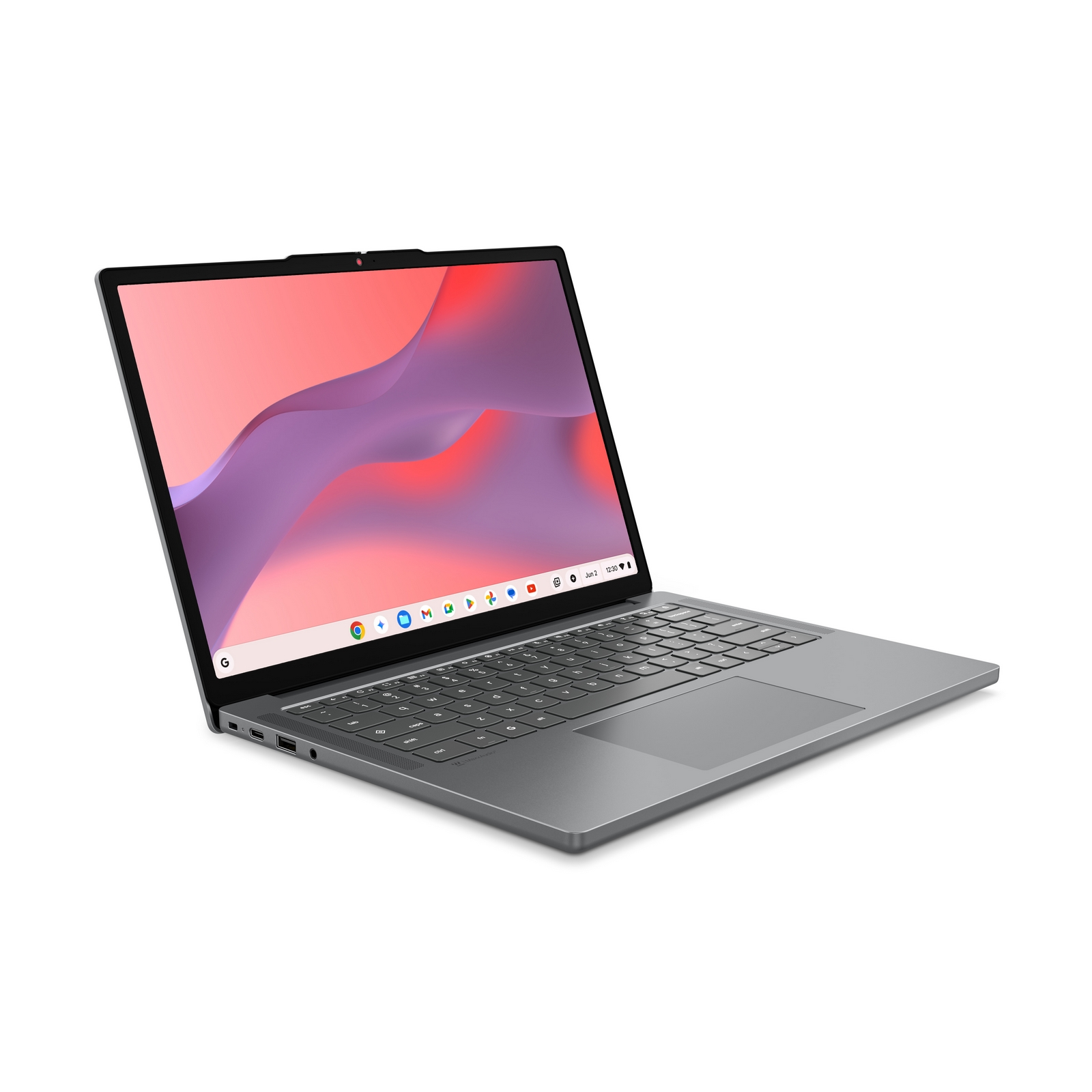 Un laptop grigio su una superficie bianca mostra uno sfondo astratto e una barra delle applicazioni aperta.