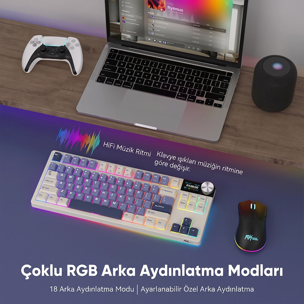 Klawiatura RGB, mysz, laptop, kontroler i głośnik na drewnianym biurku.