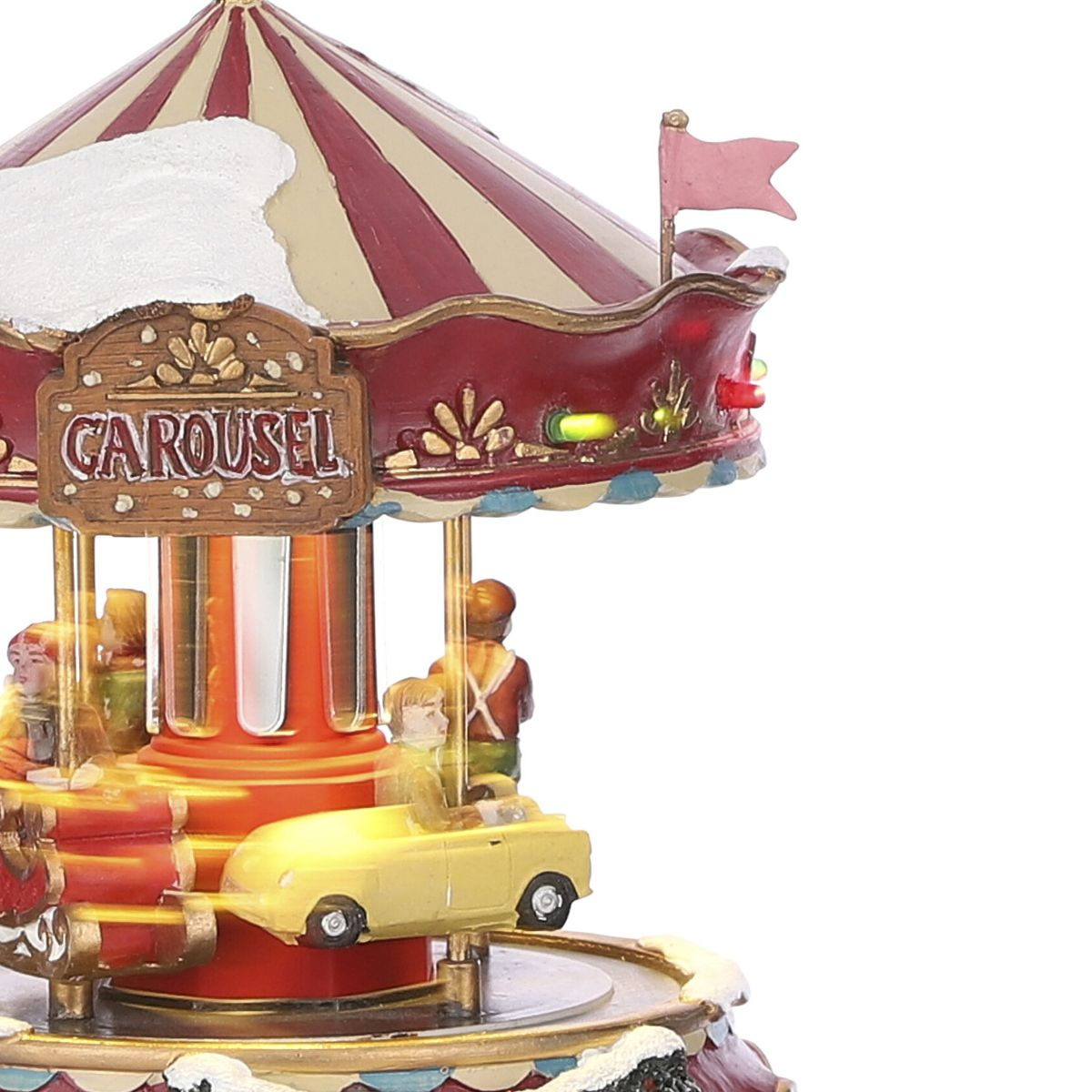 Een kleurrijke kerstcarrousel met kleine auto's en sneeuw op het dak.