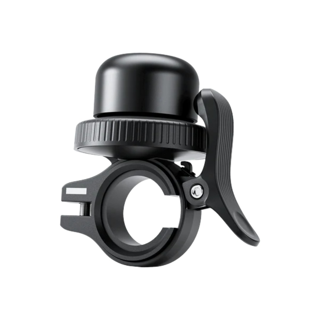 A black bicycle bell with an integrated handlebar mount on a white background.