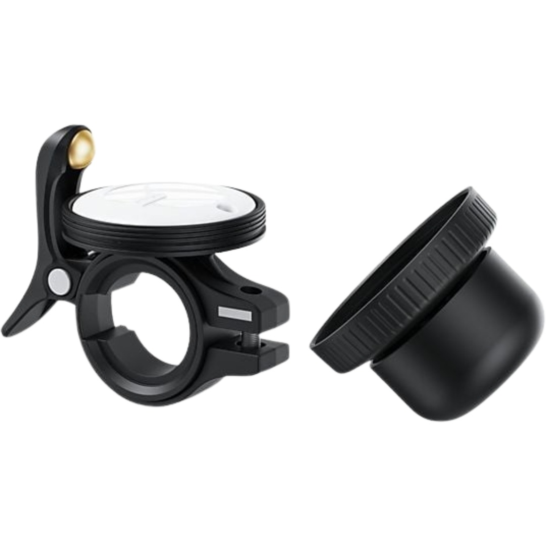 Black bicycle bell with a white top and a separate cap on a white background.