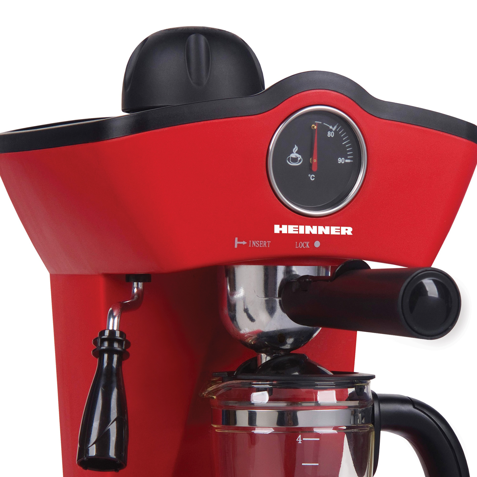 Machine à expresso Heinner rouge avec poignée noire, jauge de température et carafe en verre sur fond blanc.