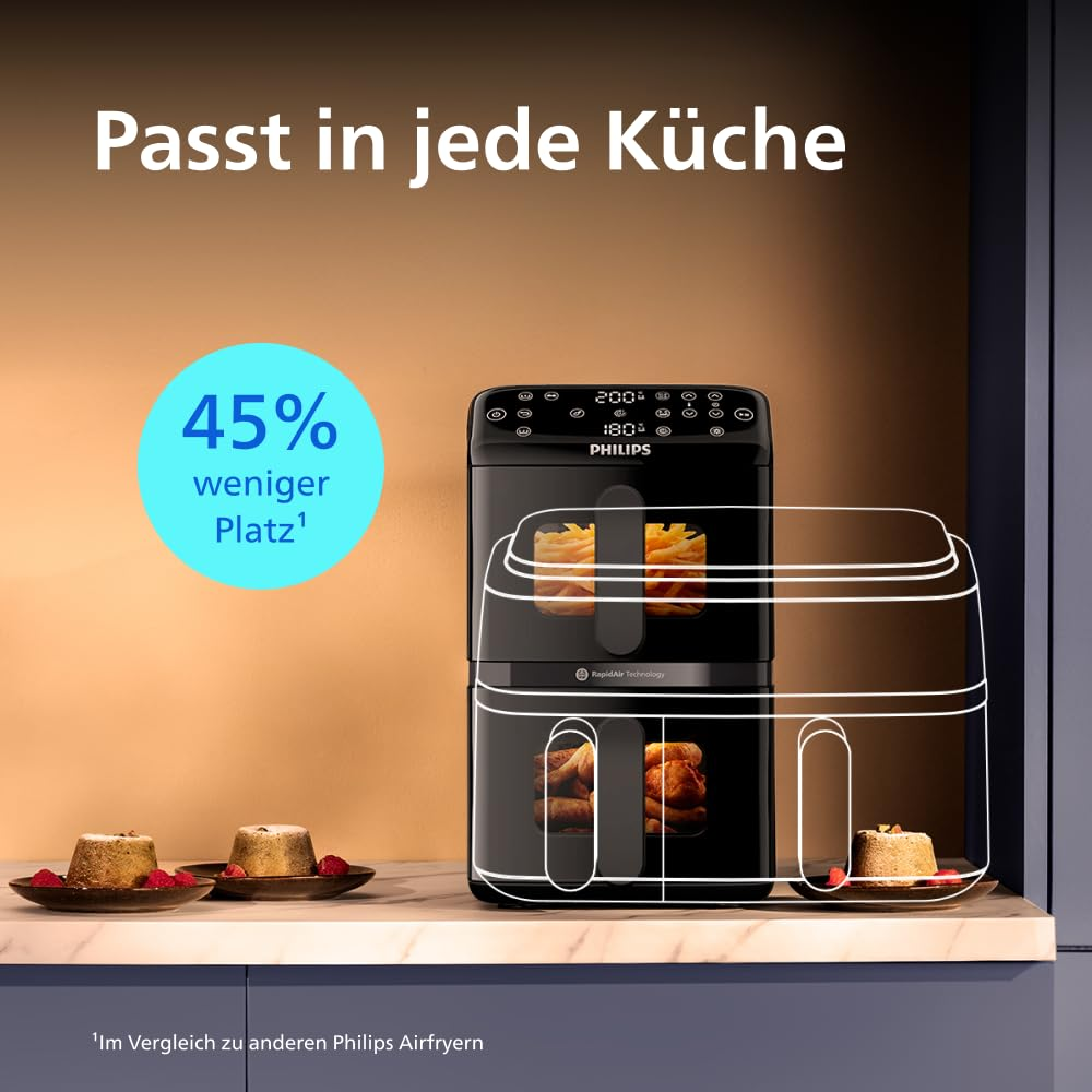 Friggitrice ad aria nera a due piani Philips su un piano cucina, circondata da piccoli dolci.